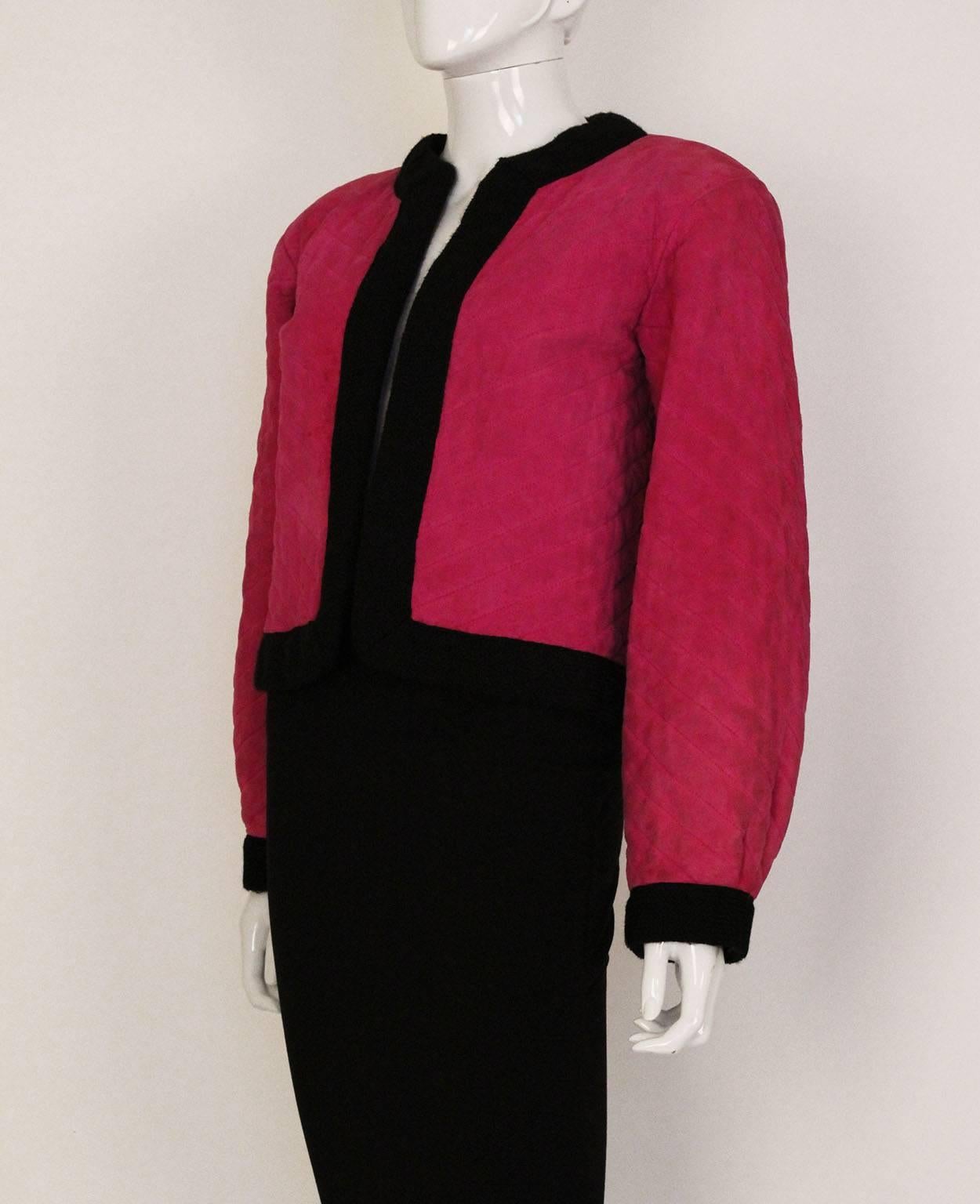 A colourful  and chic jacket by Yves Saint Laurent, model style V285.
The jacket is in a powerful pink quilted  suede , with a bright red wool/cotton mix lining.The cuffs,hem, collar and front opening are trimmed in black wool.
The jacket  is