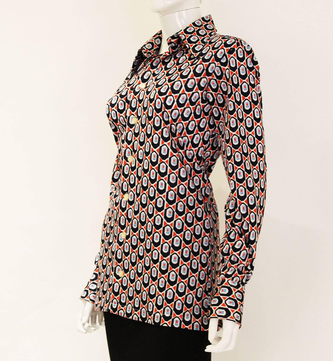 A wonderful groovy  shirt by Givenchy, Gentleman Paris. In a great print,the colours are red,navy blue, sky blue and white.The shirt has a two button cuff and large pointed collar,