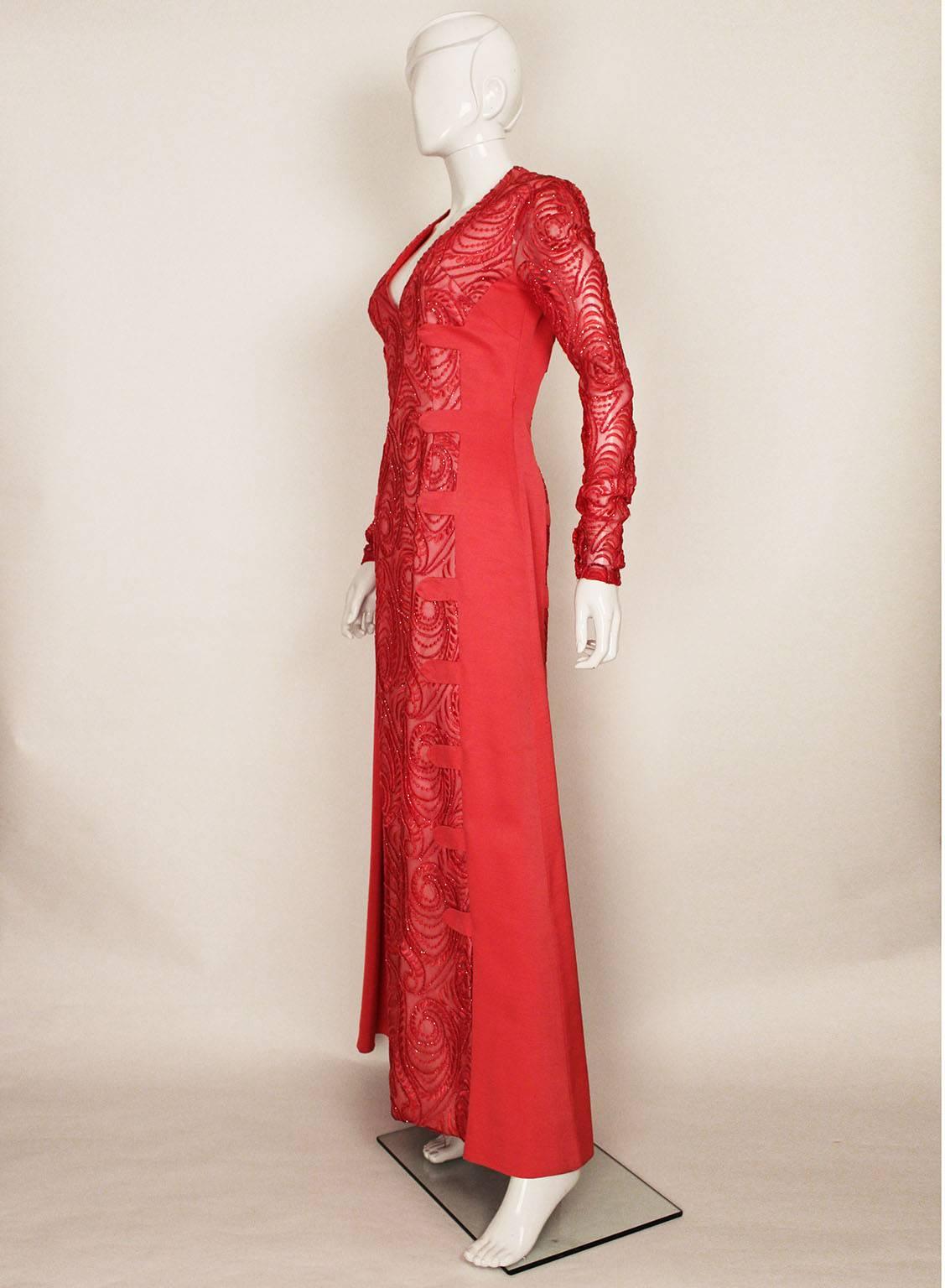 A stunning gown by Dior from the 1960s. In a wonderful rose pink colour the gown has a central devoree panel on the front and back . The sleeves are also devoree,and the sides panels with detail are pink silk.There are two slits on either side of