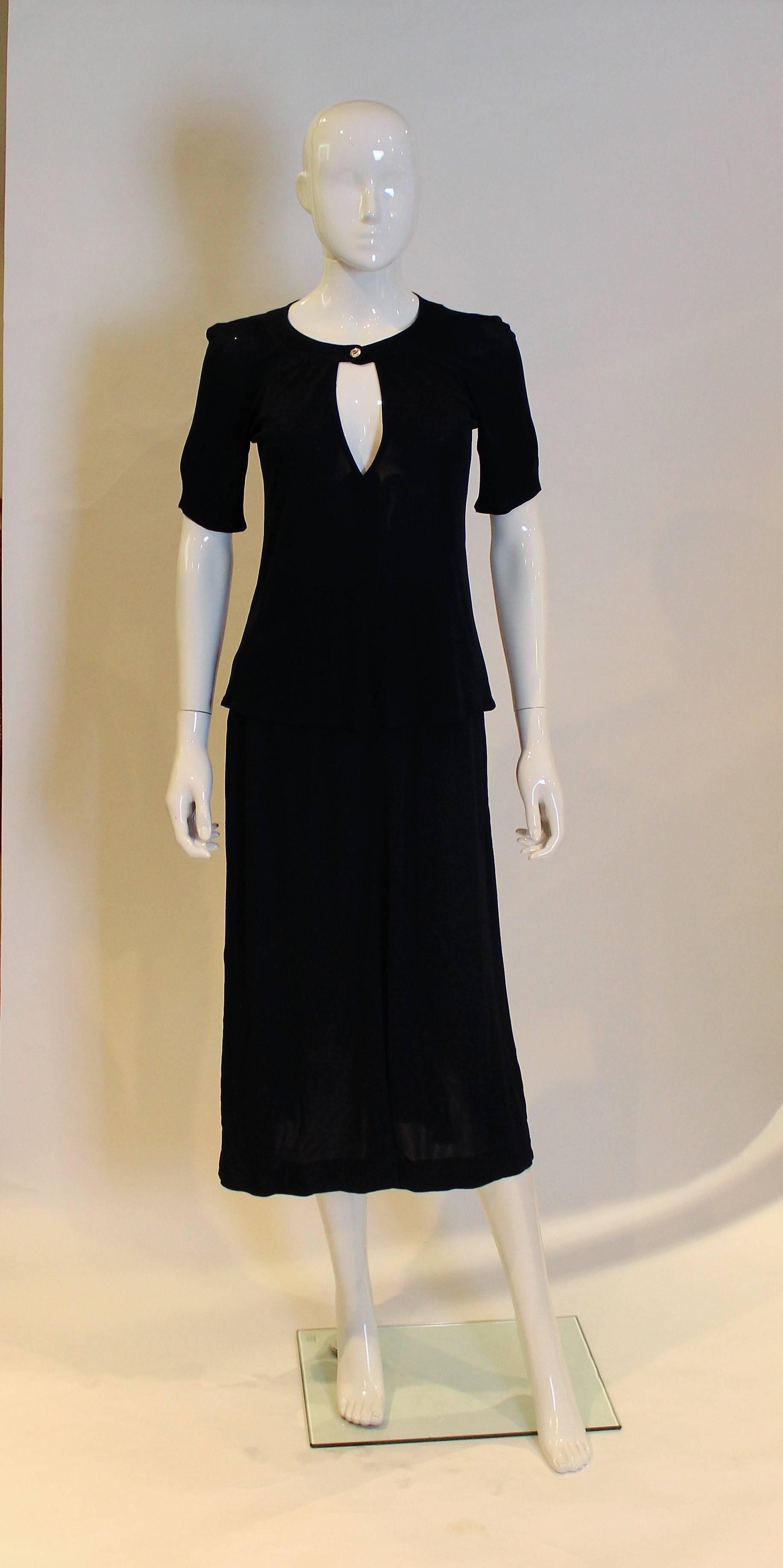 A chic and esy to wear outfit by Jean Muir. The top fastens with one button and has a large keyhole opening. The skirt  has pleast from below the waistband.
Top: Bust 33, length 22'', Skirt : waist 24'', length 31''
