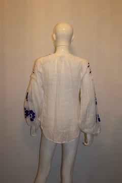 Stunningwhite blouse with blue embroidery by March 11