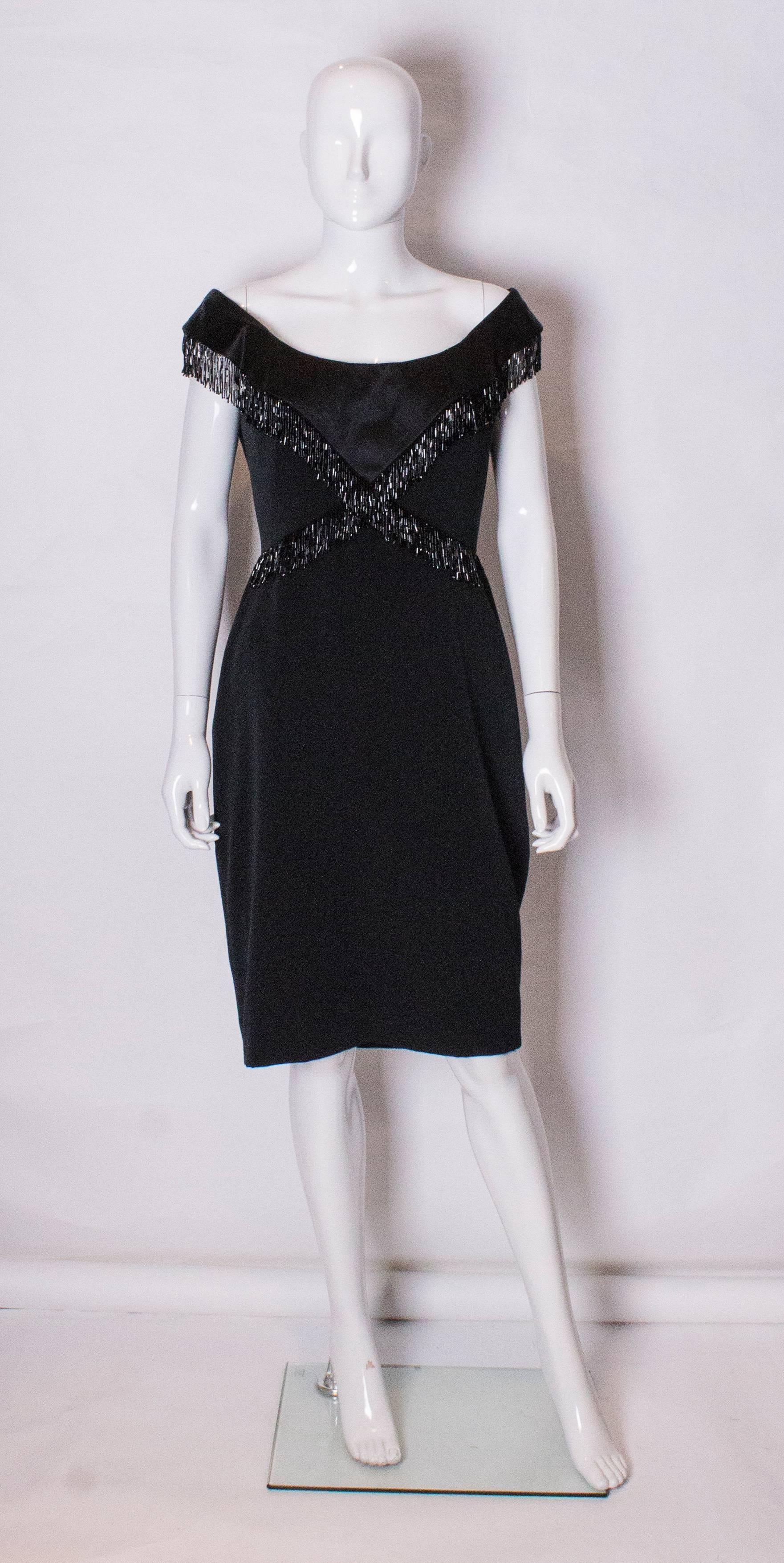 A chic cocktail dress by Bellvillse Sassoon.,The dress has a low boat neckline, and beading across the bust and waist. The dress is fully lined and has a central back zip.