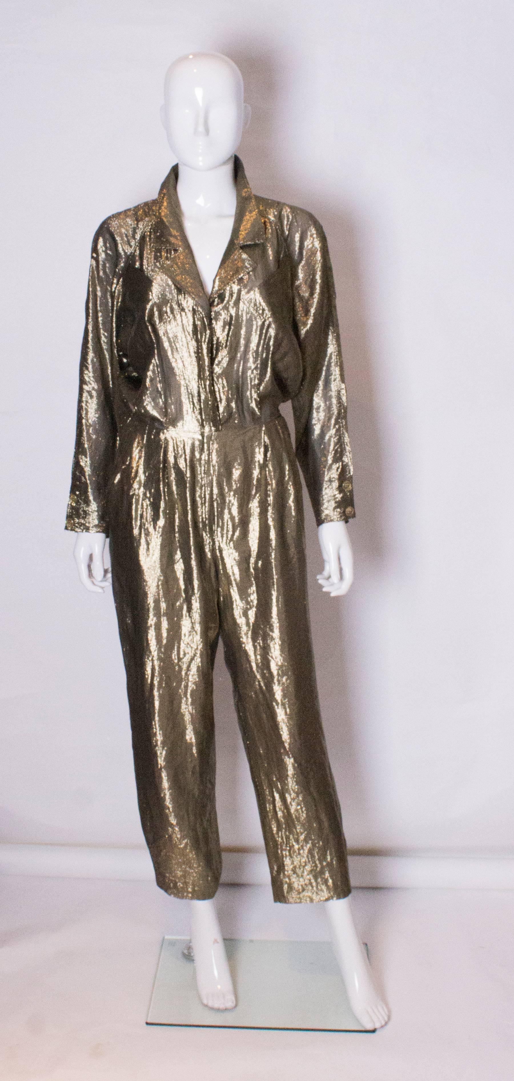  A great party outfit by the Italian firm Fendi. The jumpsuit has a zip from the waist down , and poppers from the waist up.The legs are lined , and there are double buttons at the sleeve end.There are diagonal pockets at bust level and hip level.