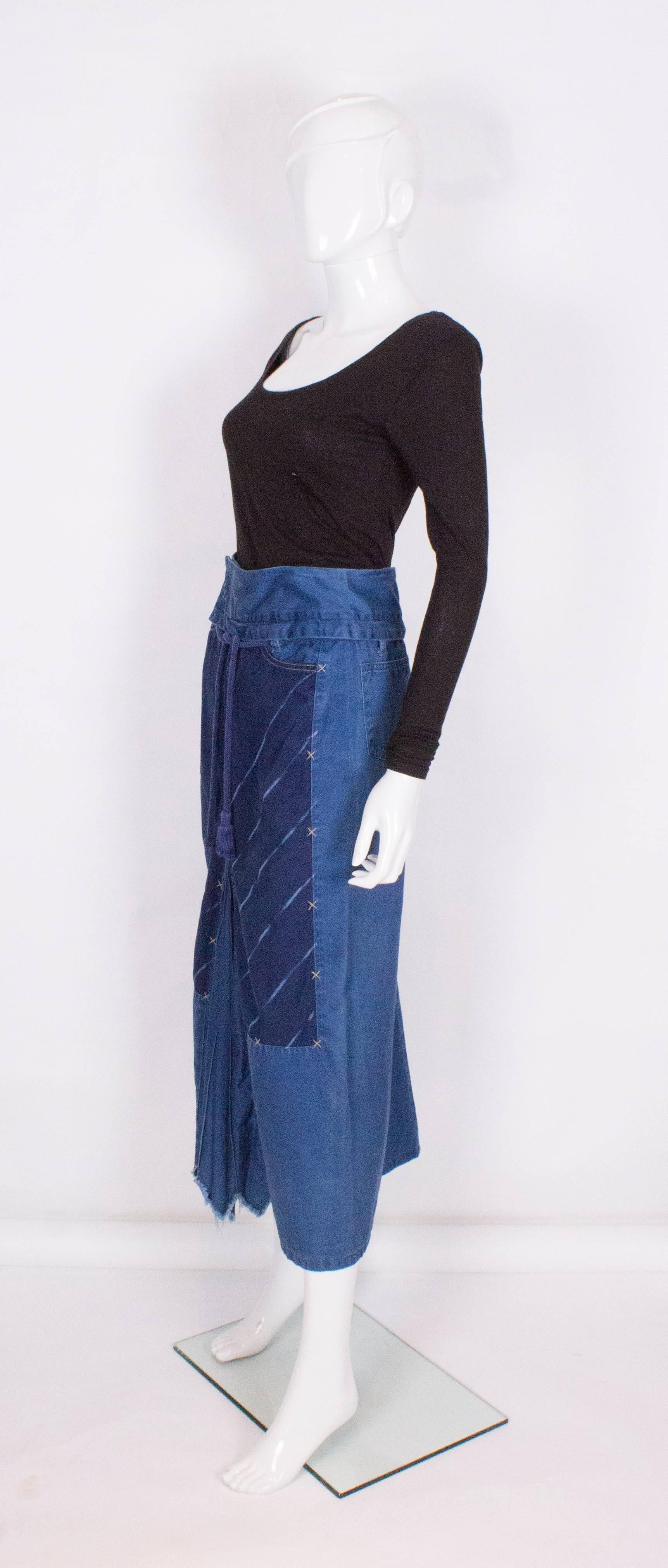 A great skirt by French designer , Marithe Francois Girbaud,The skirt is slightly A line with 2 back pockets, 2 front pockets, a poper opening at the front, and a front pleat detail.