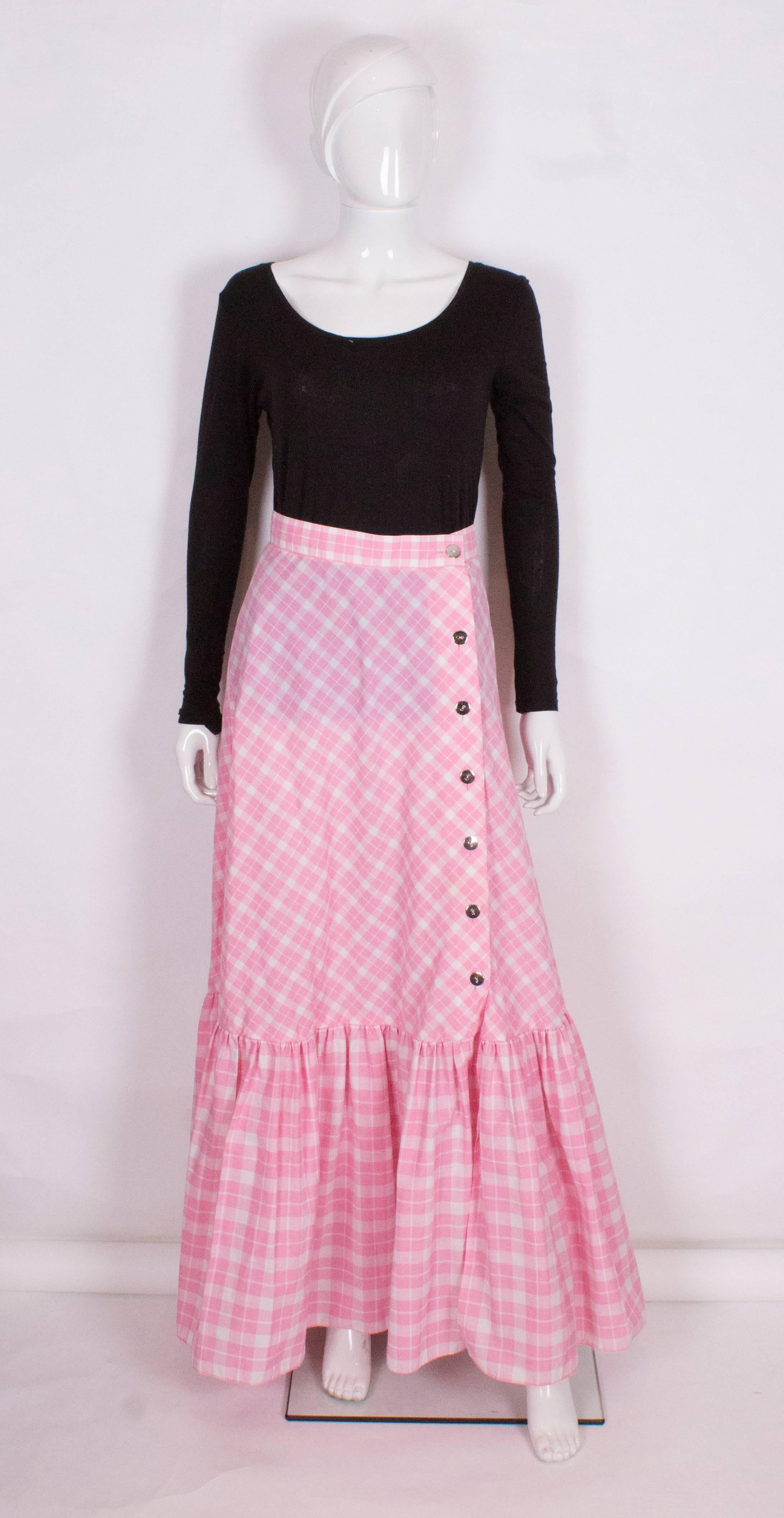 A great skirt by Louis Feraid in  a pink and white check. The skirt has an off centre 7 button opening ,and 18'' frill at the bottom.