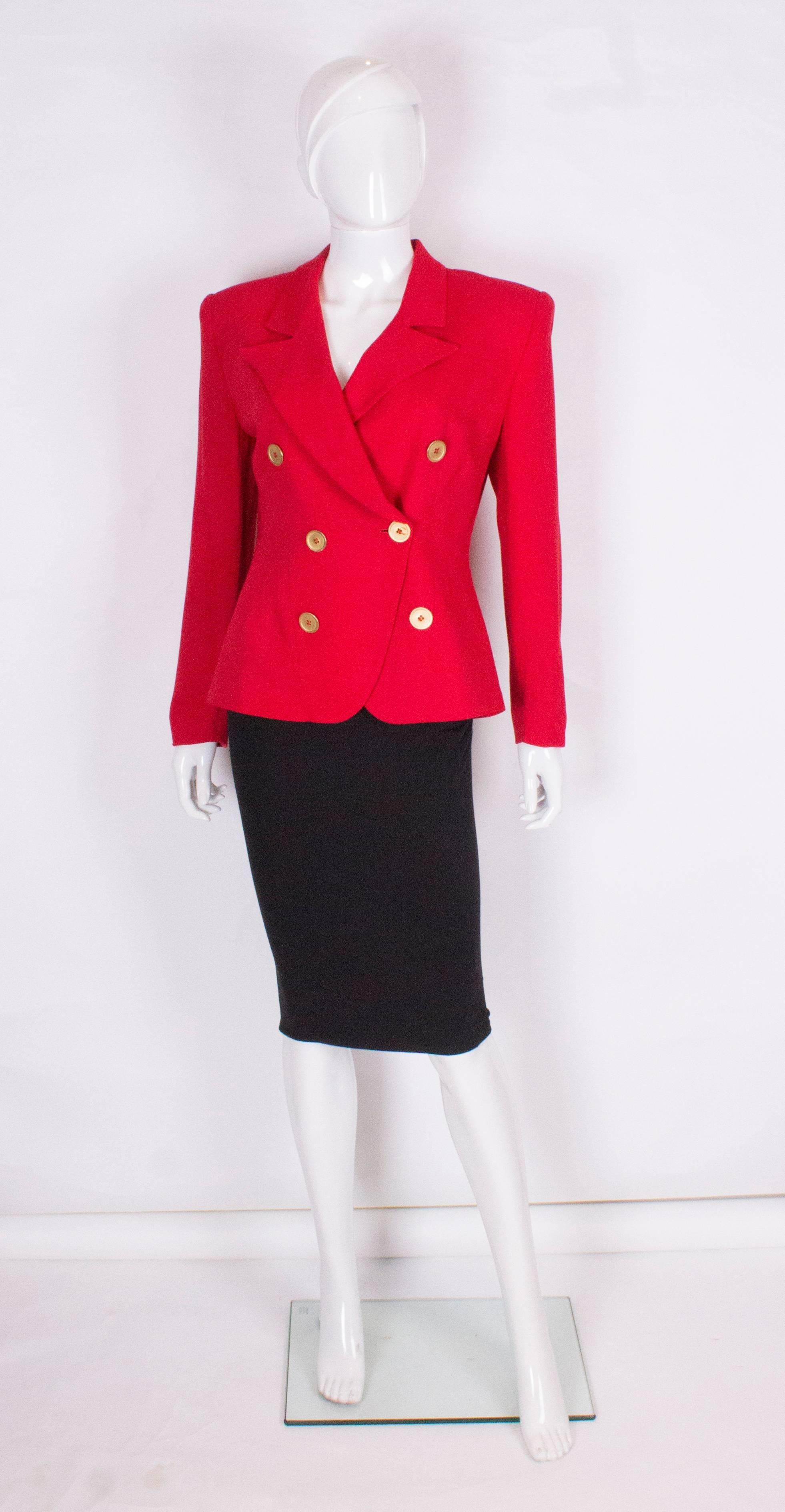 A great red jacket by Christian Dior.The jacket is double breasted with 6 buttons on the front and one on each cuff.The jacket is fully lined, and has an interesting curve design at the front.