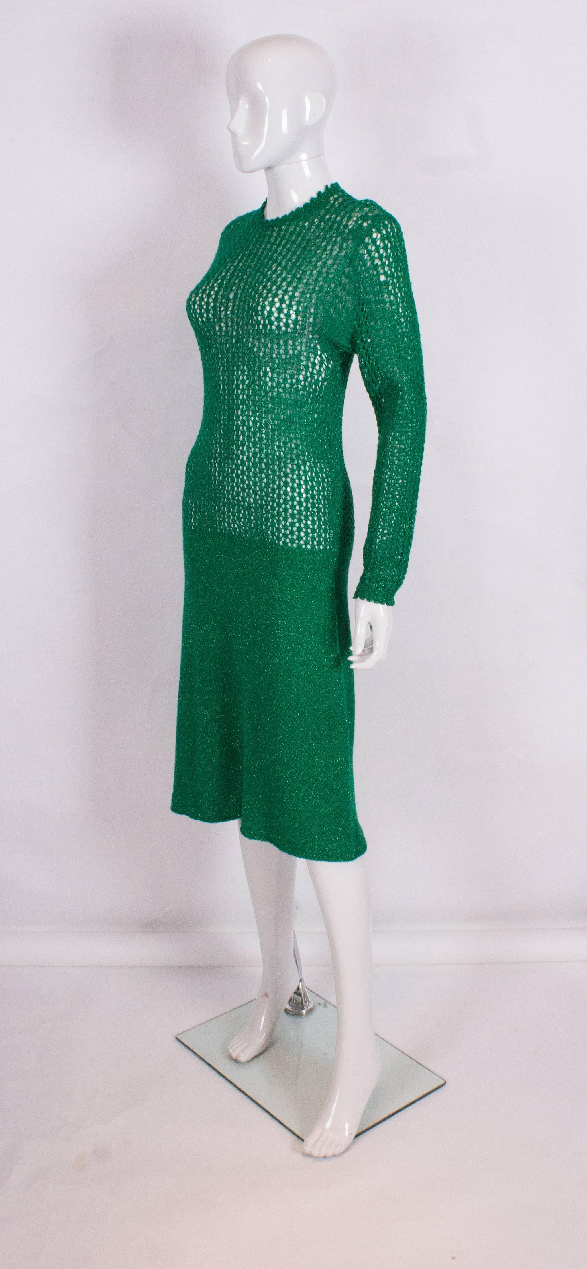 A great knitted dress, in a lovely shade of green with subtle sparkles.The dress has a round neck, popper opening at the back and an Aline skirt in a tighter knit.