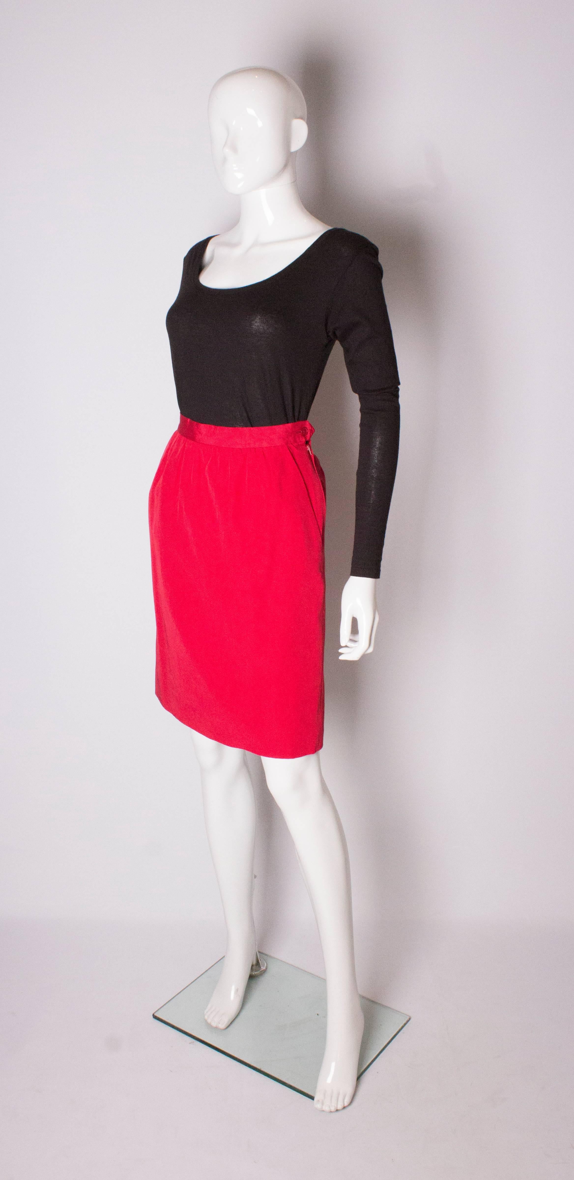 A chic skirt by Yves Saint Laurent, Rive Gauche line. The skirt is a cotton and viscose mix ( 53% cotton, 47% viscose). It has sloping pockets on each side , gathering at the waist and a zip on the left hand side.
