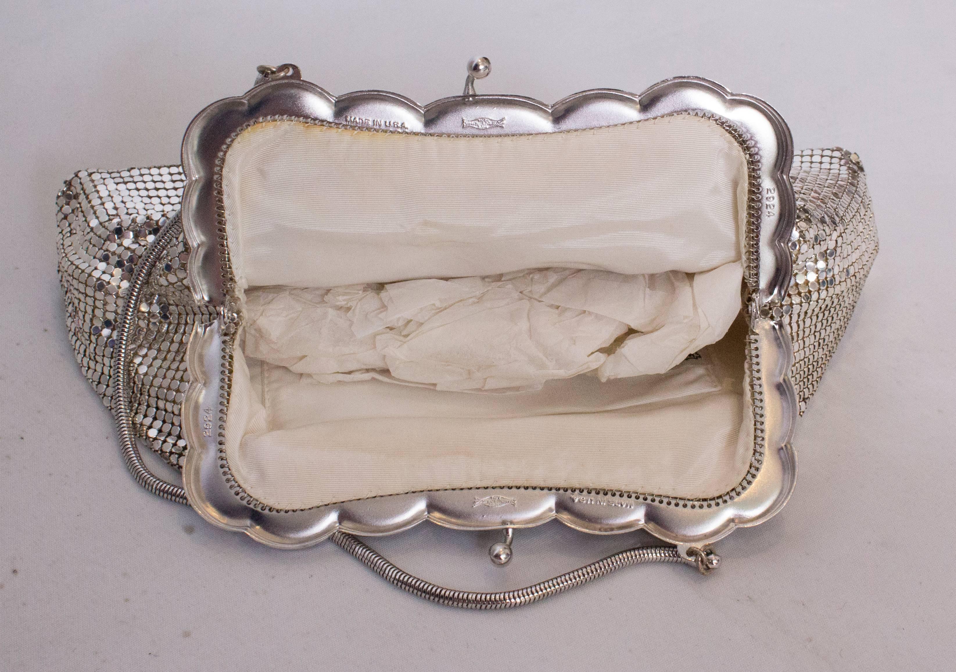 A great bag by US firm Whiting and Davis , style 2924. The bag is in excellen condition,  and is large enough to carry evening reuqirements. The bag is in  a silver mesh with a scallop frame and satin lined.