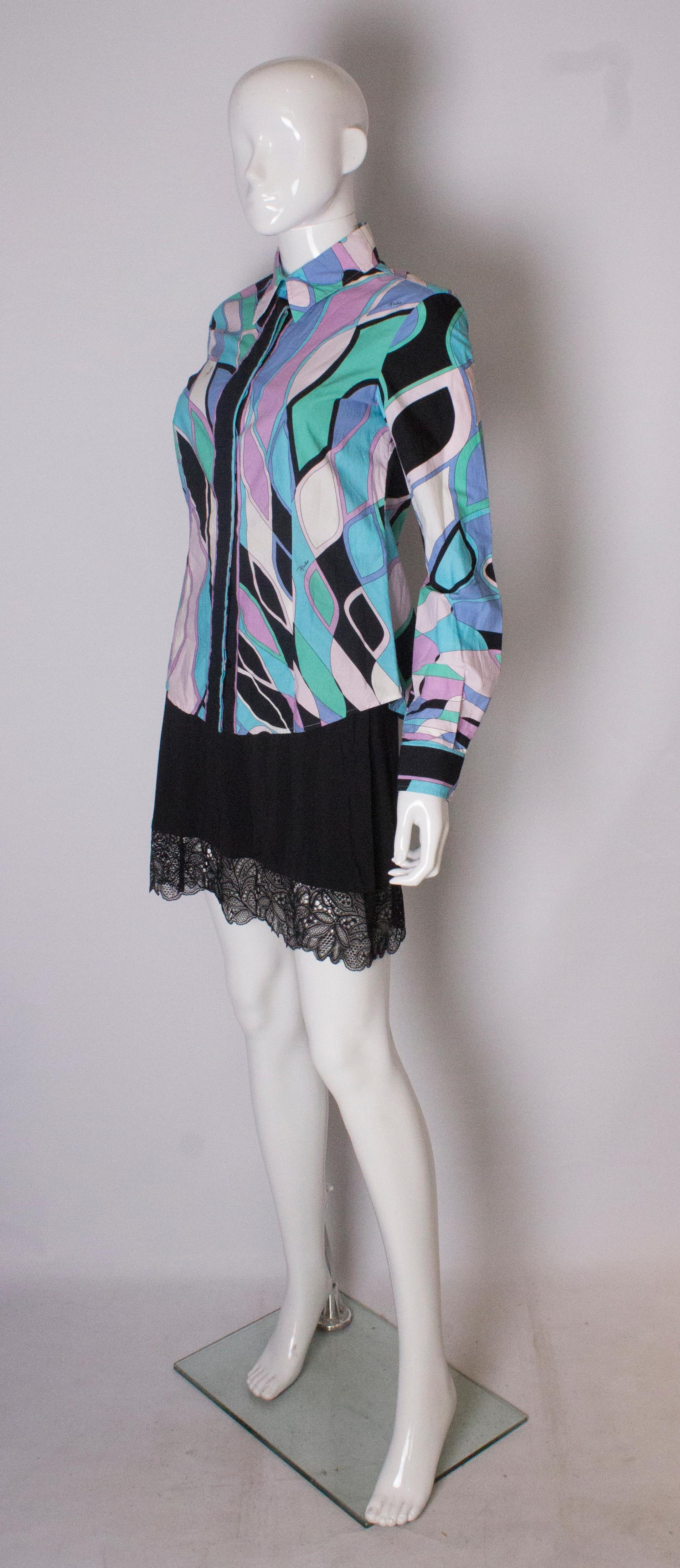 A great shirt by Emilio Pucci. This cotton shirt is a wonderful mix of colours, blue,white,black ,green,pink and lilac, with Emilio printed on the shirt.The buttons on the front are covered by the shirt giving it a polished look,and all the buttons