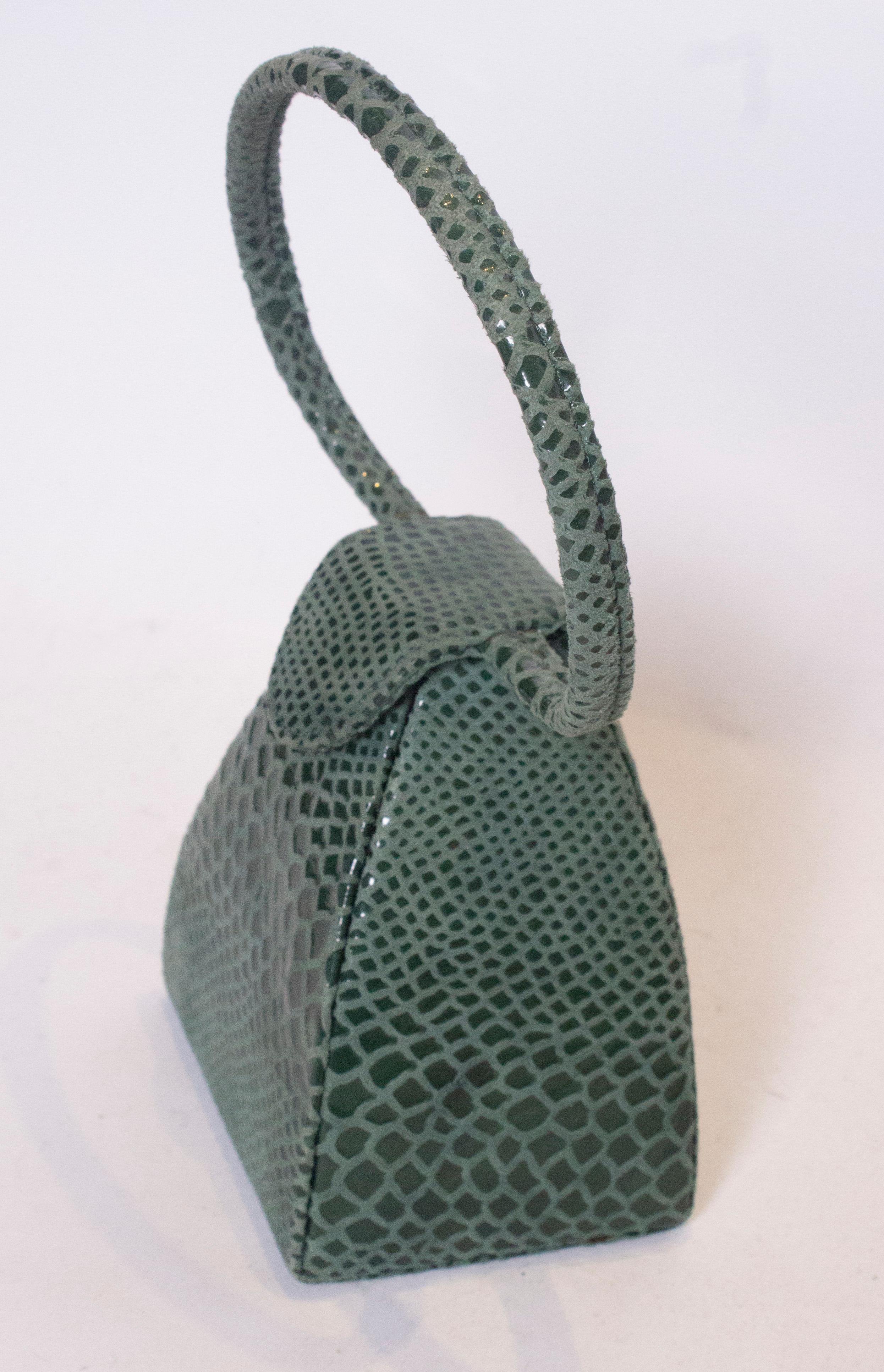 A chic vintage box bag in a lovely green colour 'snakeskin' . The bag has a chic round handle and popper fastening at the top , its a great shape.  Measurements: width 4 1/2'', height 6'', depth 4''
