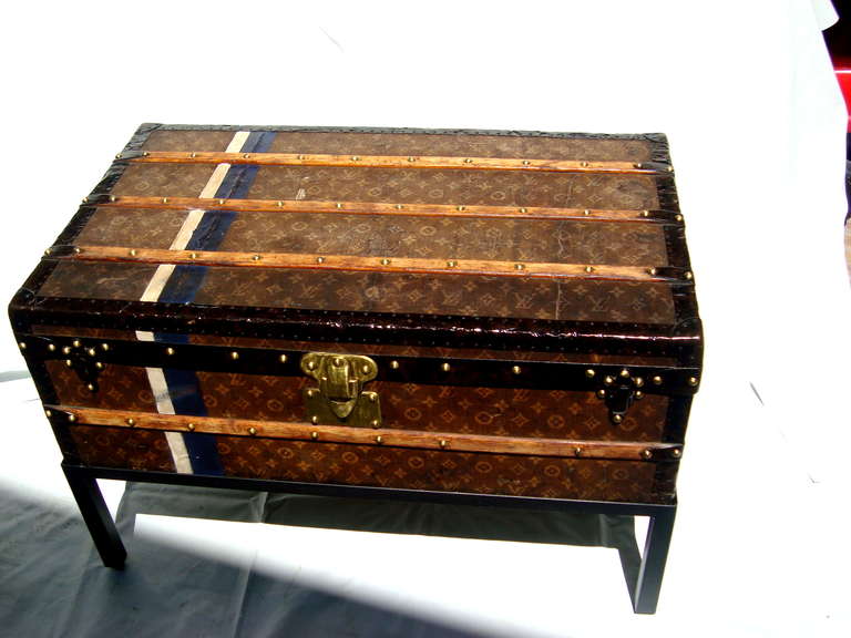 Beautiful antique louis vuitton cabin trunk coffee table circa 1907.  All hardware is original and stamped Louis Vuitton.  Original red striped interior with removeable tray and the original LV key works the lock.  Custom welded steel base has