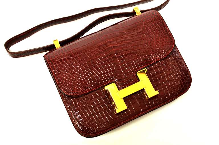 Women's Vintage Hermes 22cm Constance in Burgundy Crocodile with Gold Hardware.