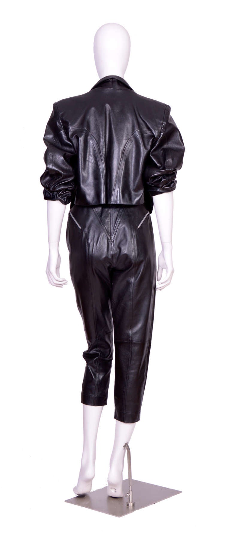 Iconic vintage 80's Alaia black leather suit. 
Jacket French size 42
Trousers French Size 40
Measurements taken flat:
Trousers: waist 13,5inch/34cm(x2) - Hip 20inch/51cm(x2) - inseam 25inch/64cm - rise 15inch/38cm
Jacket: Sh to Sh 18inch/46cm - Ua