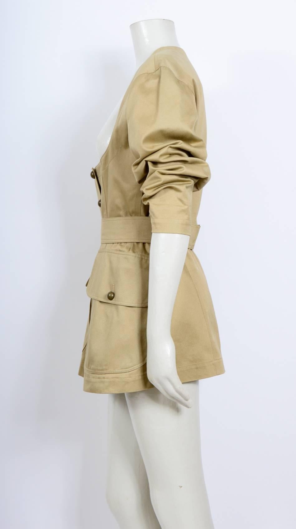Iconic Alaia Cotton Safari Jacket from the late 80's.
Dome shape buttons and attached belt - Unlined
Size  French 42 - US 10 - UK 14
Measurements taken flat: Length 29,5inch/75cm - Ua to Ua 18,5inch/47cm - waist 16inch/41cm - hips 21inch/55cm