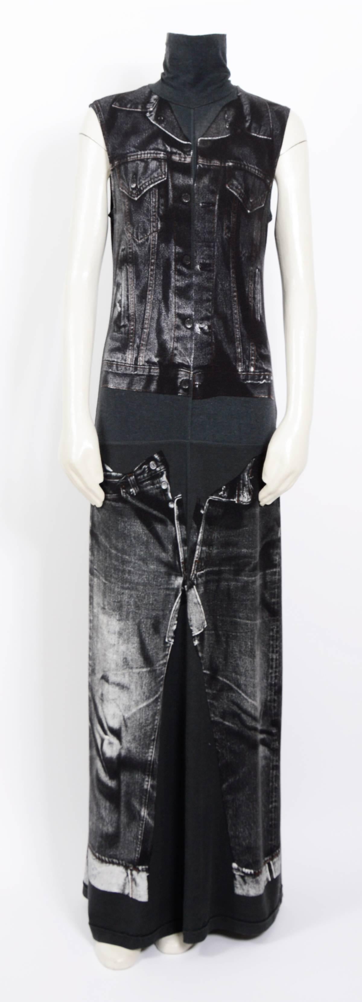 Iconic dress from Jean Paul Gaultier in a black jersey with a trompe l'oeil denim  jacket and jeans screen printed on the front and back. It has a turtle neck and skims the body then flares to the hem.  It pulls on over the head and is unlined. Very