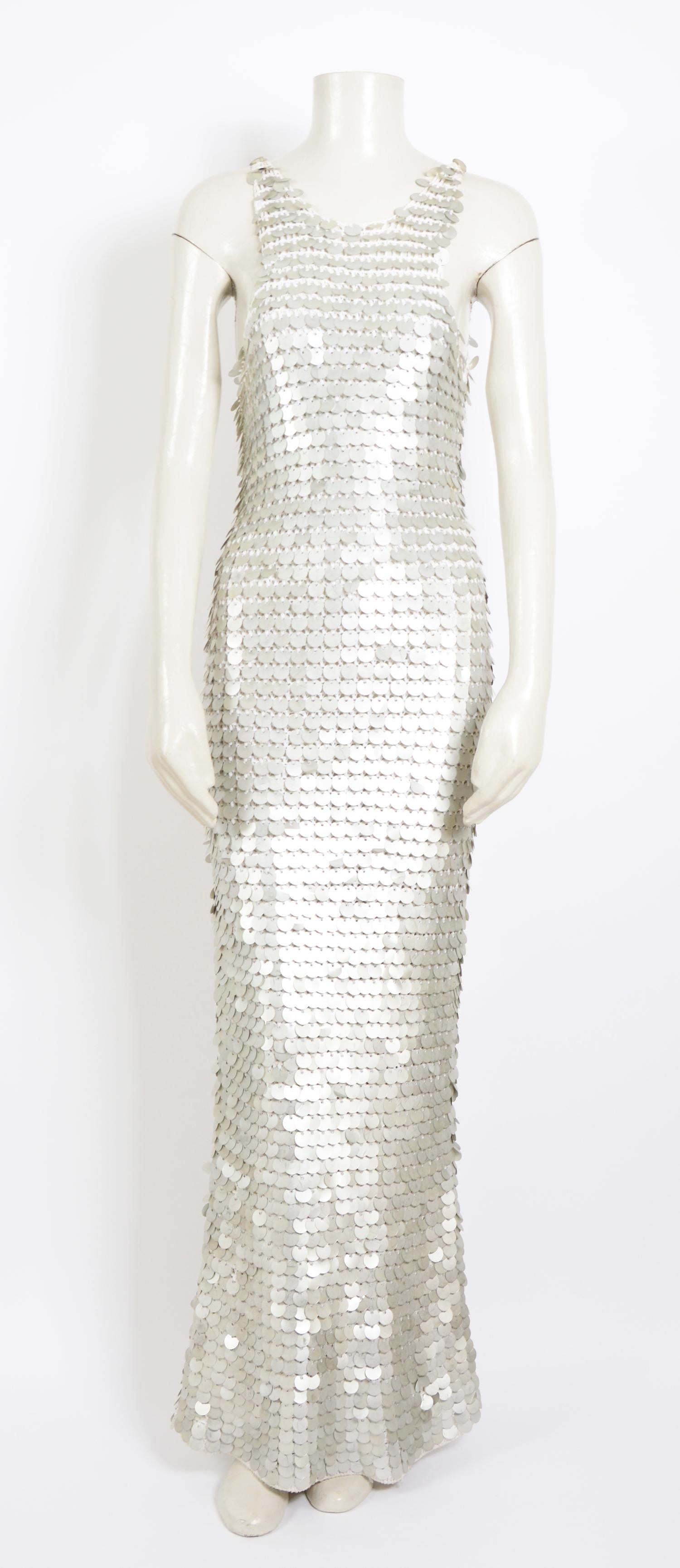 Late 60's early 70's sheer white crochet slip dress, adorned with Paco Rabanne style silver or metallic disc or sequins.
This fabulous dress is hand-crocheted from white cotton yarn.
Hundreds of oversized Paco Rabanne style metallic disc are affixed