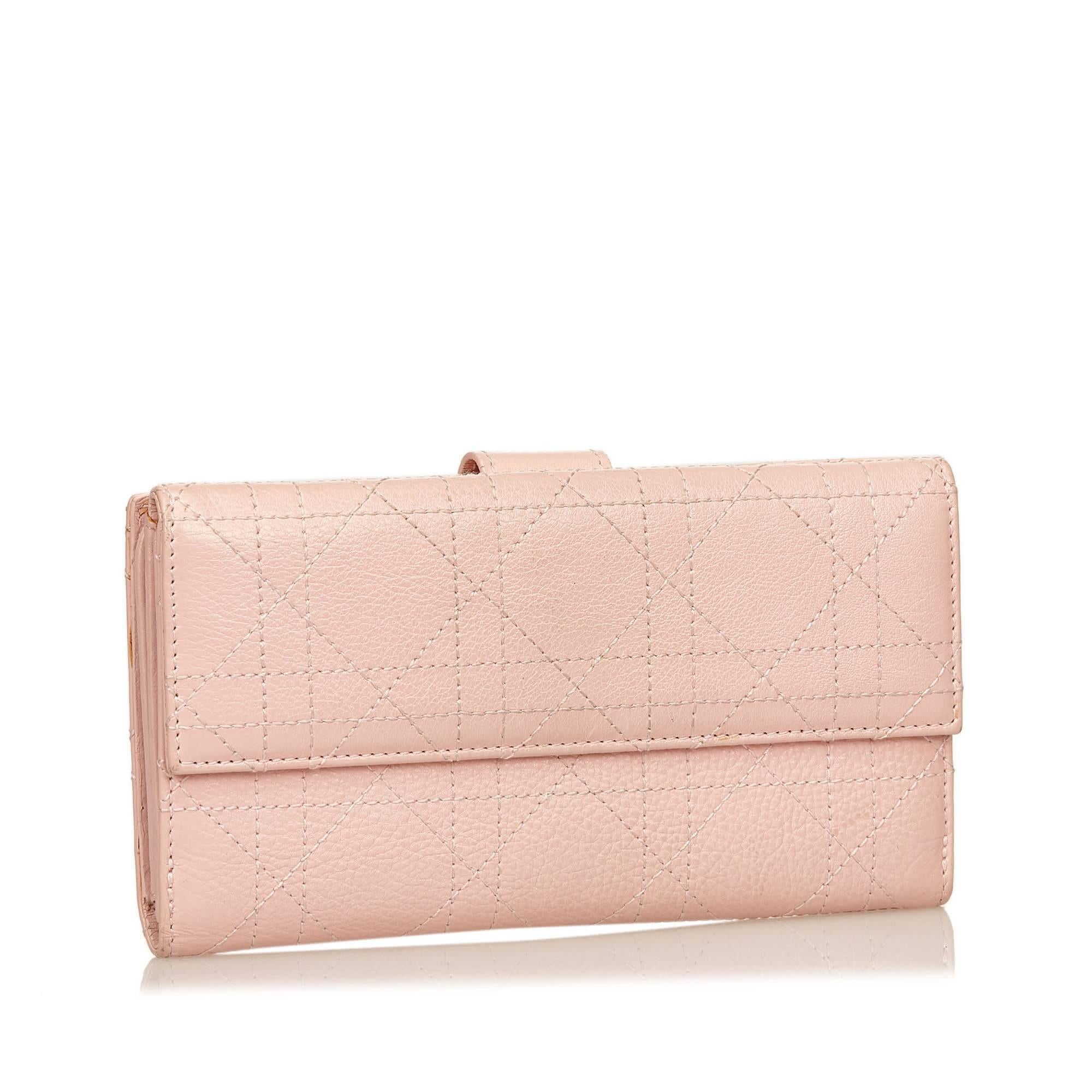 This CD wallet features a cannage leather body, an exterior strap compartment, a front flap with a magnetic closure, and interior slip pockets.

Color: Pink
