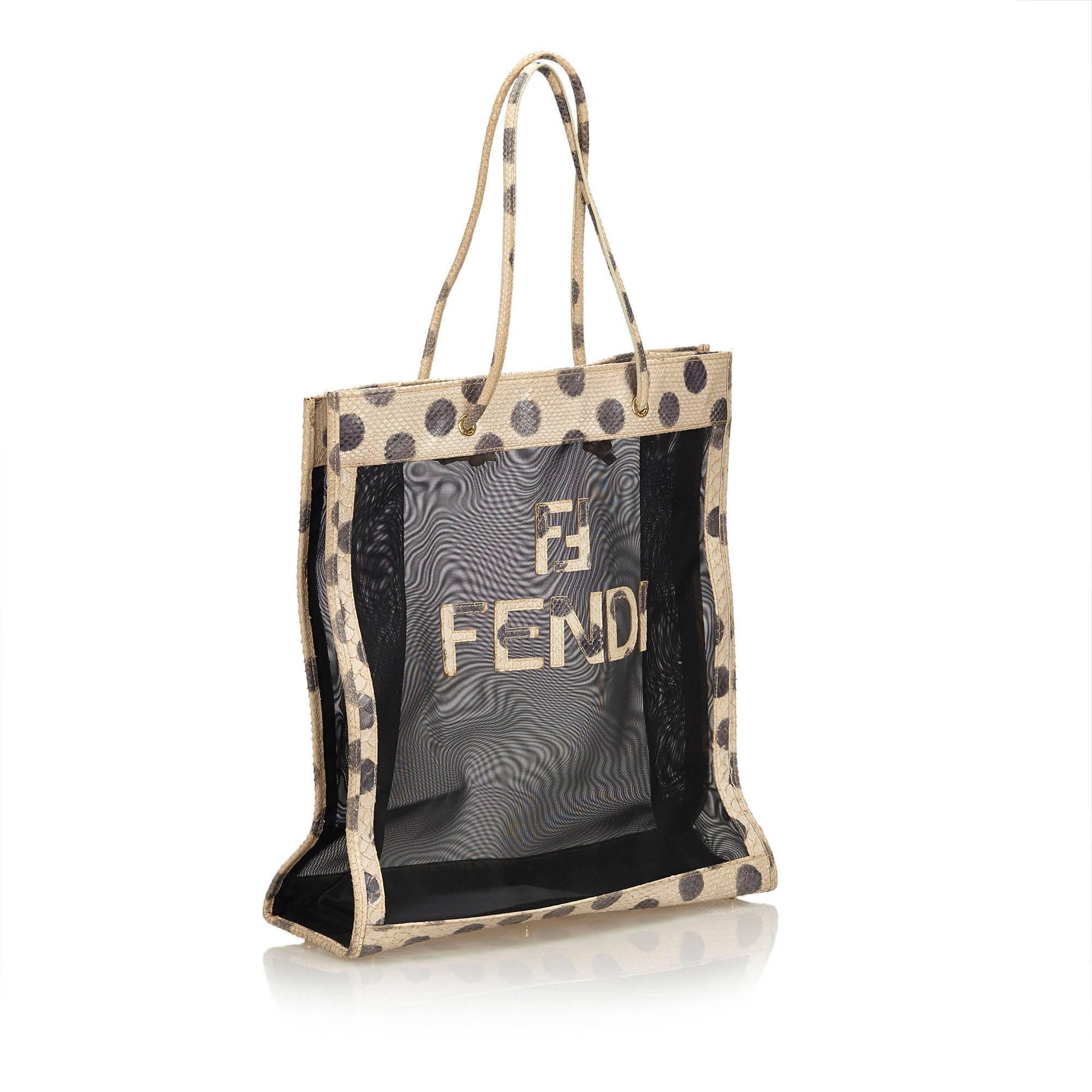 This tote bag features a mesh body with polka dot leather trim, leather strap, and an open top. 

It carries a B condition rating.

Dimensions: 
Length 36 cm
Width 38 cm
Depth 12 cm
Drop 22 cm

Inclusions: Dust Bag

Color: Black x White x