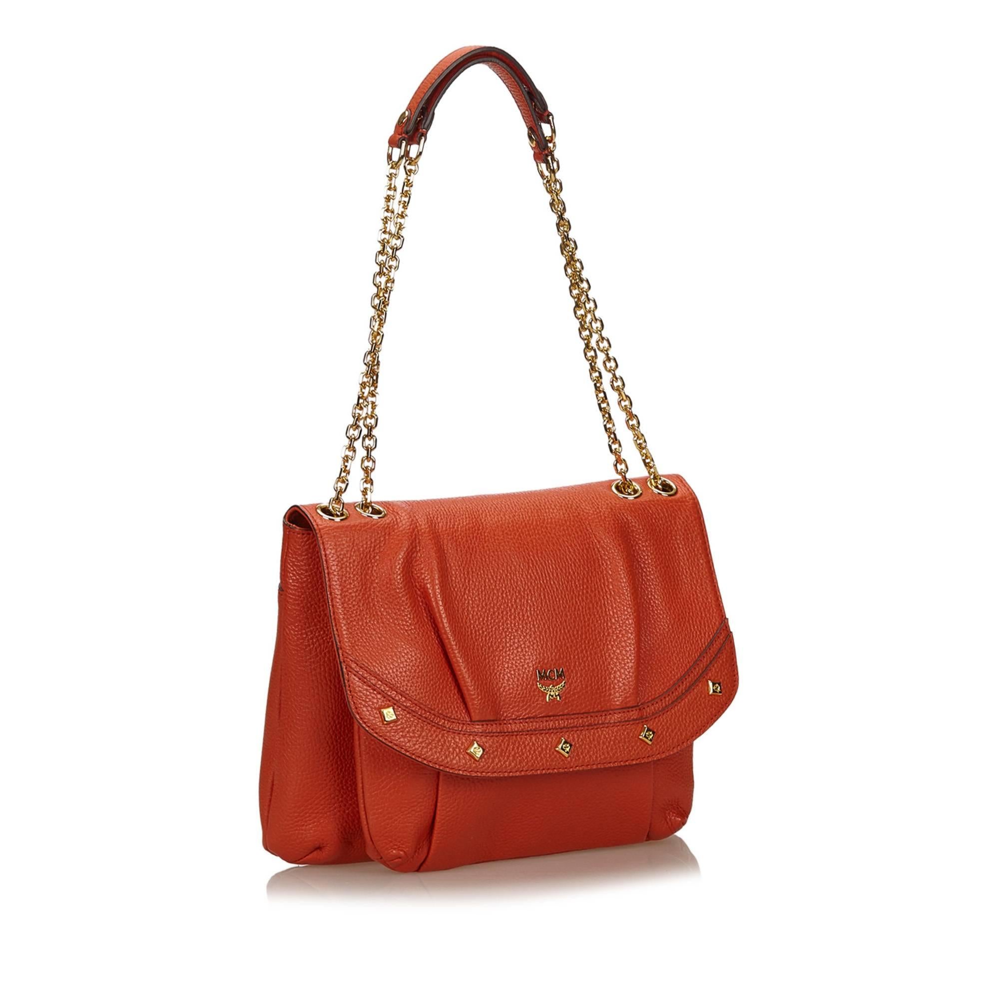 This shoulder bag features a leather body, gold-tone studs, flat leather straps with gold-tone chain, front flap, and interior zip and slip pockets. 

It carries an A condition rating.

Dimensions: 
Length 24 cm
Width 29 cm
Depth 3 cm
Shoulder Drop