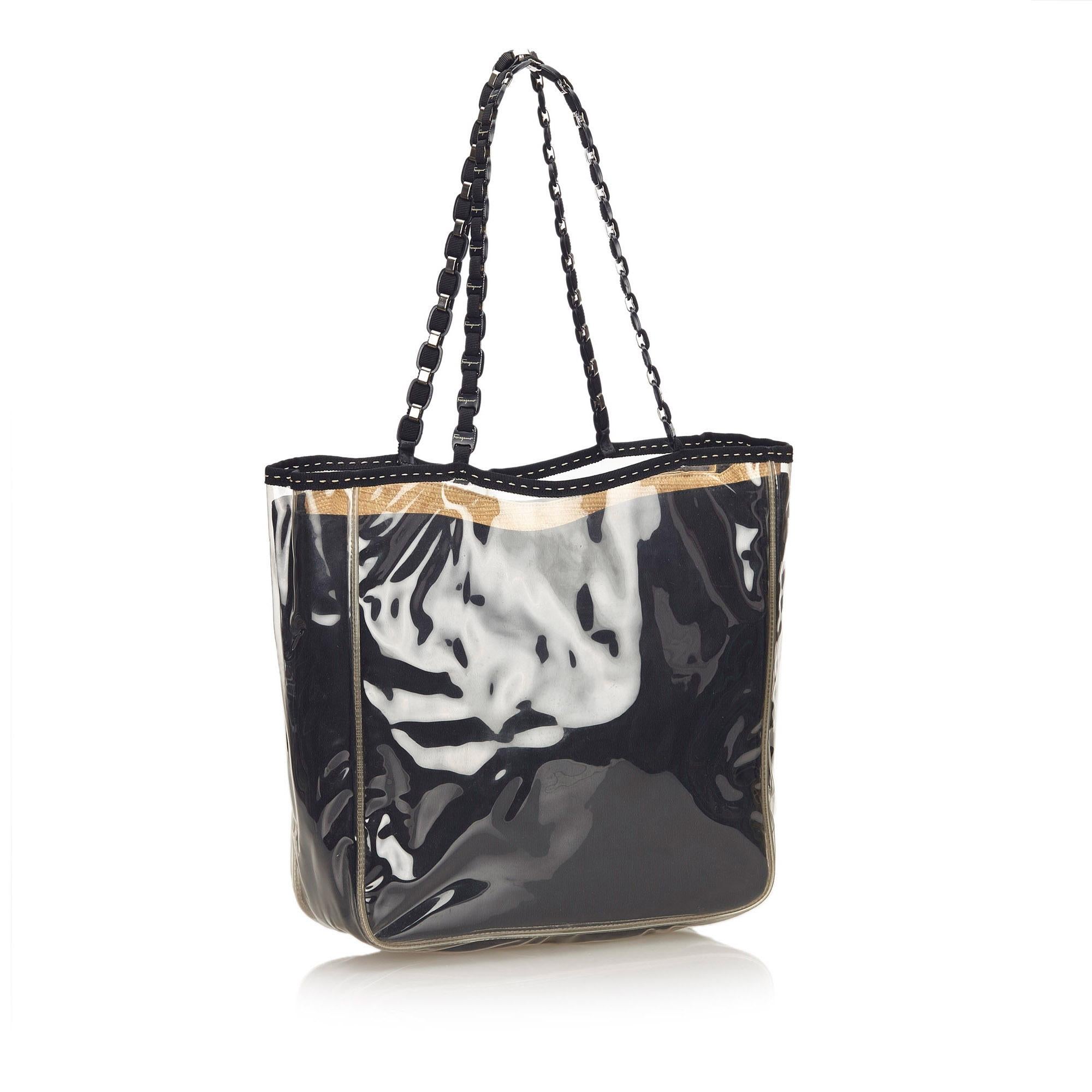 This tote bag features a vinyl body, flat nylon straps and top button closure. It carries a B condition rating.

Dimensions: 
Length 23 cm
Width 33 cm
Depth 11 cm

Inclusions: No longer comes with original accessories.

Color: Black

Material: