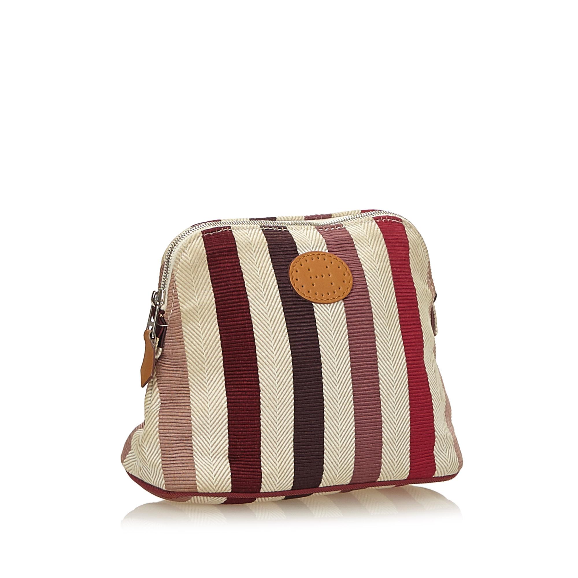 The Bolide Pouch features a cotton body and a top zip closure.

It carries a B+ condition rating.

Dimensions: 
Length 14.00 cm
Width 19.00 cm
Depth 7.00 cm

Inclusions: Box, 

Color: White x Ivory x Multi

Material: Fabric x Cotton

Country of