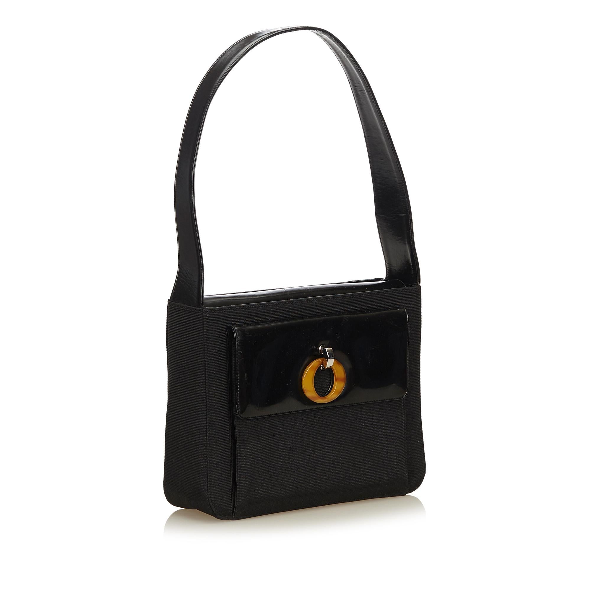 This shoulder bag features a chemical fiber body, flat strap, hidden flap closure, and an exterior envelope pocket.

It carries a B+ condition rating.

Dimensions: 
Length 20.00 cm
Width 25.00 cm
Depth 7.00 cm
Shoulder Drop 25.50 cm

Inclusions: No