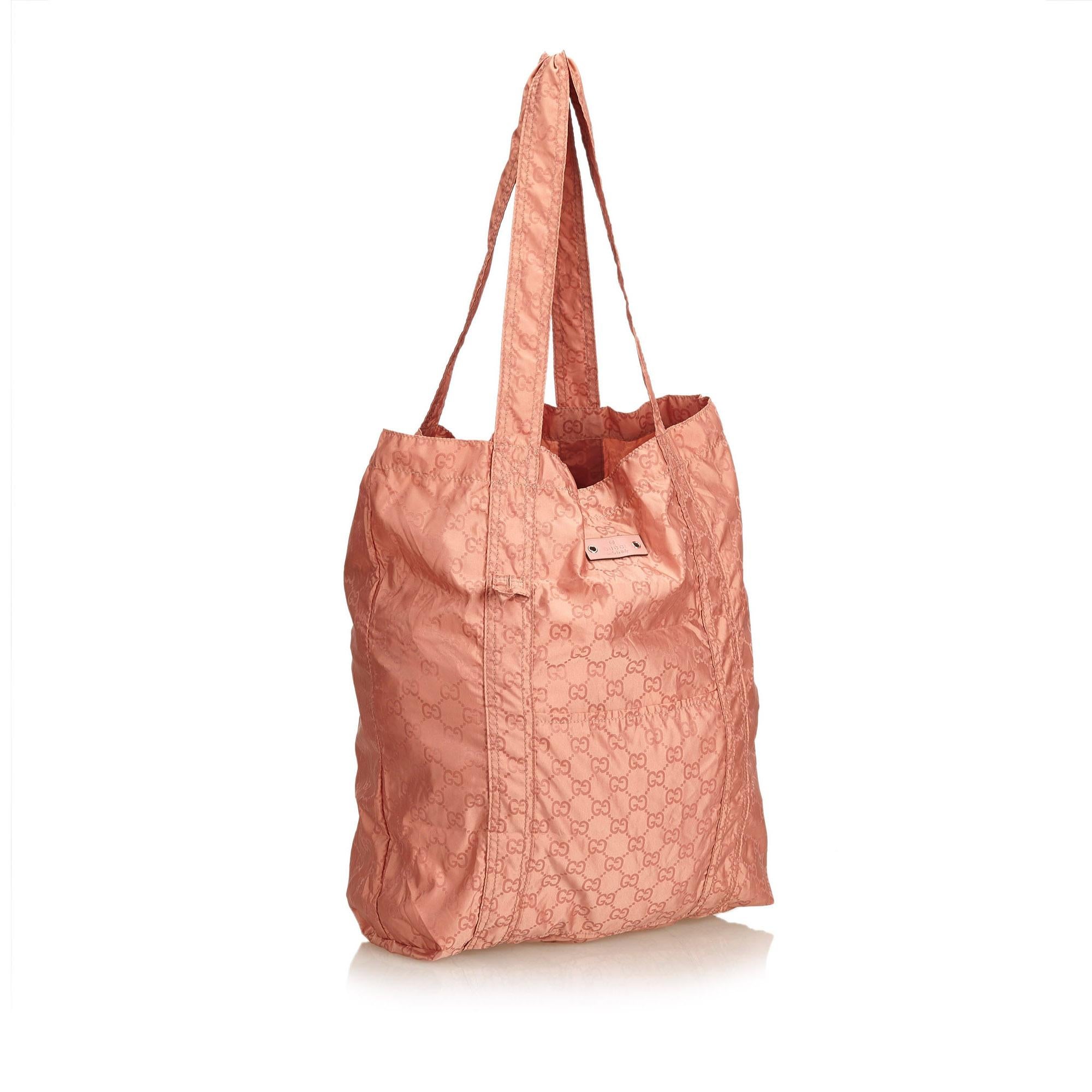 This tote bag features a nylon body, flat nylon strap, open top, and an exterior front open pocket.

It carries a AB condition rating.

Dimensions: 
Length 39.00 cm
Width 27.50 cm
Depth 10.50 cm
Shoulder Drop 28.00 cm

Inclusions: Pouch

Color: