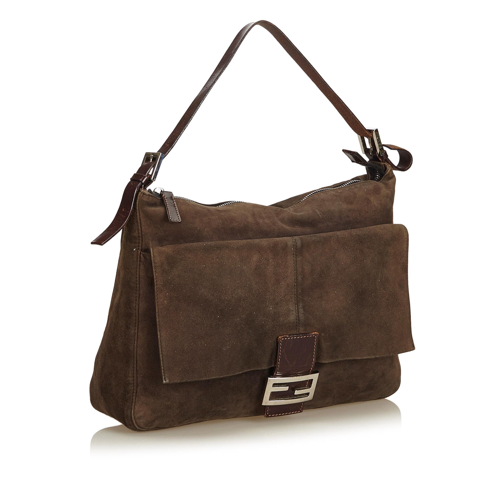 This Mamma Forever features a suede body, flat leather strap, top zip closure, exterior flap pocket with flat leather strap and magnetic snap button closure, and interior zip pocket.

It carries a B+ condition rating.

Dimensions: 
Length 26.00