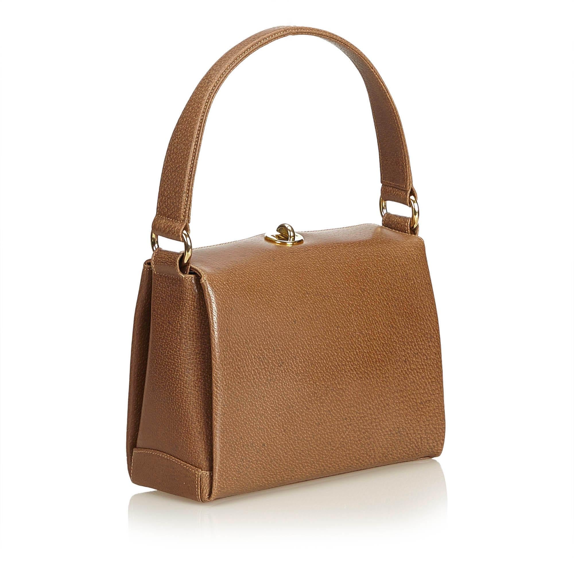 This handbag features a leather body, flat top handle, top flap with twist-lock closure, and interior zip and open pockets.

It carries a AB condition rating.

Dimensions: 
Length 16.00 cm
Width 21.00 cm
Depth 6.50 cm
Hand Drop 14.00 cm

Inclusions: