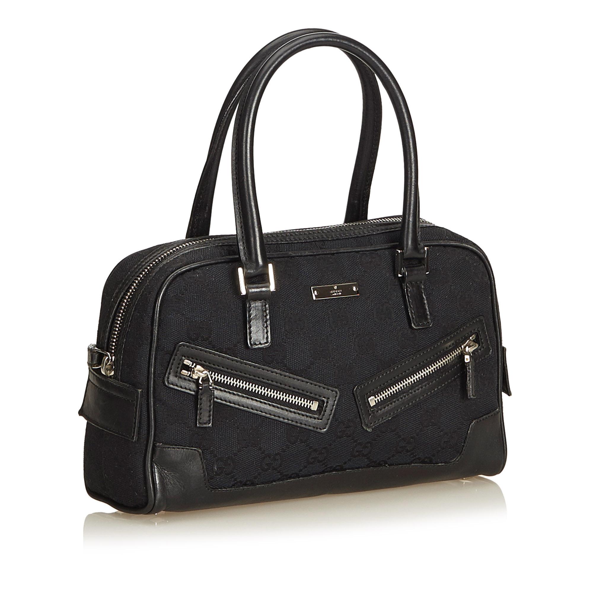 This boston bag features a canvas body with leather trim, rolled leather handles, top zip closure, exterior zip pockets, and interior zip pocket.

It carries a B+ condition rating.

Dimensions: 
Length 16.00 cm
Width 23.00 cm
Depth 7.00 cm
Shoulder