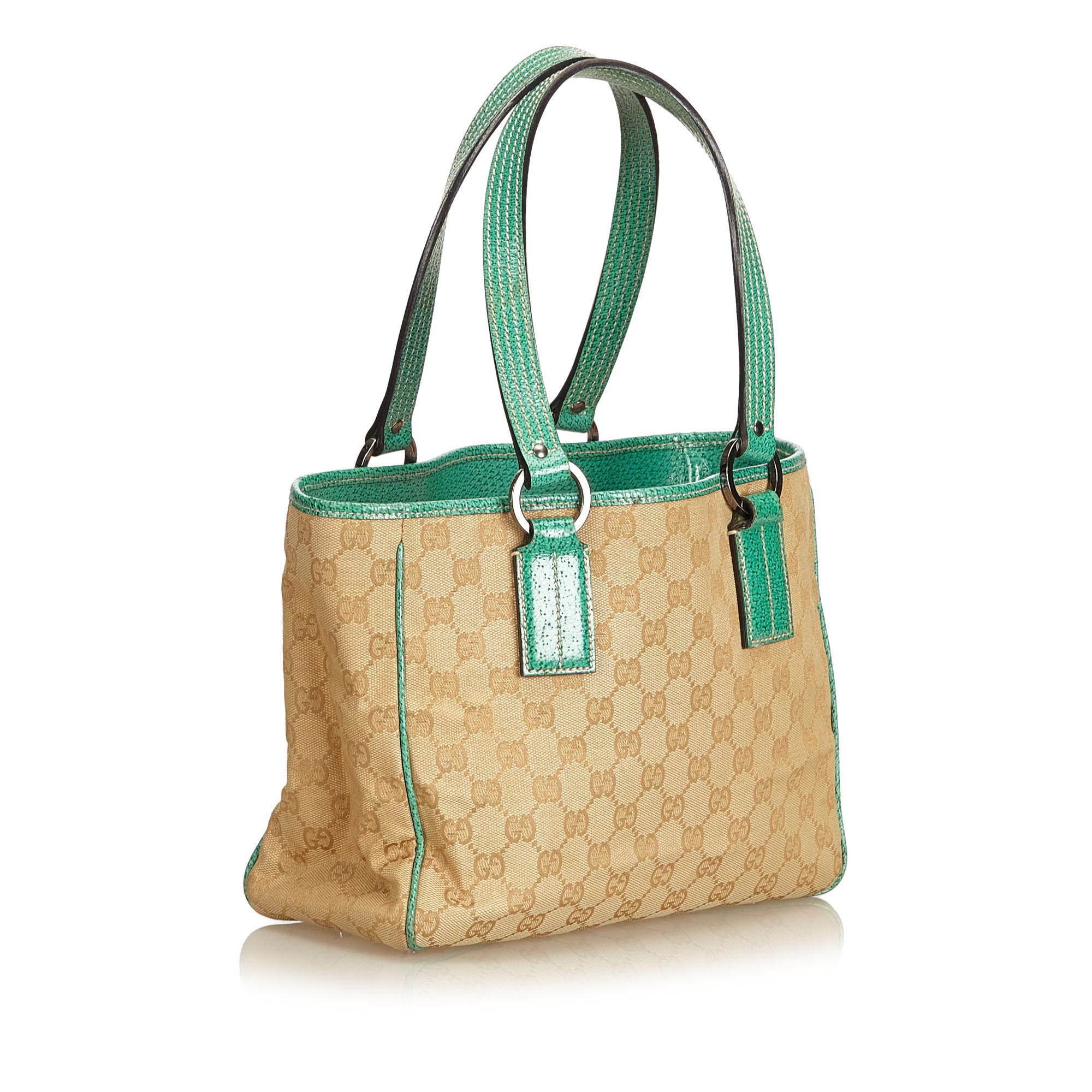 This tote bag features a jacquard body with leather trim, flat leather straps, open top, and interior zip pocket.

It carries a B+ condition rating.

Dimensions: 
Length 21.00 cm
Width 27.50 cm
Depth 10.50 cm
Drop 19.50

Inclusions: No longer comes
