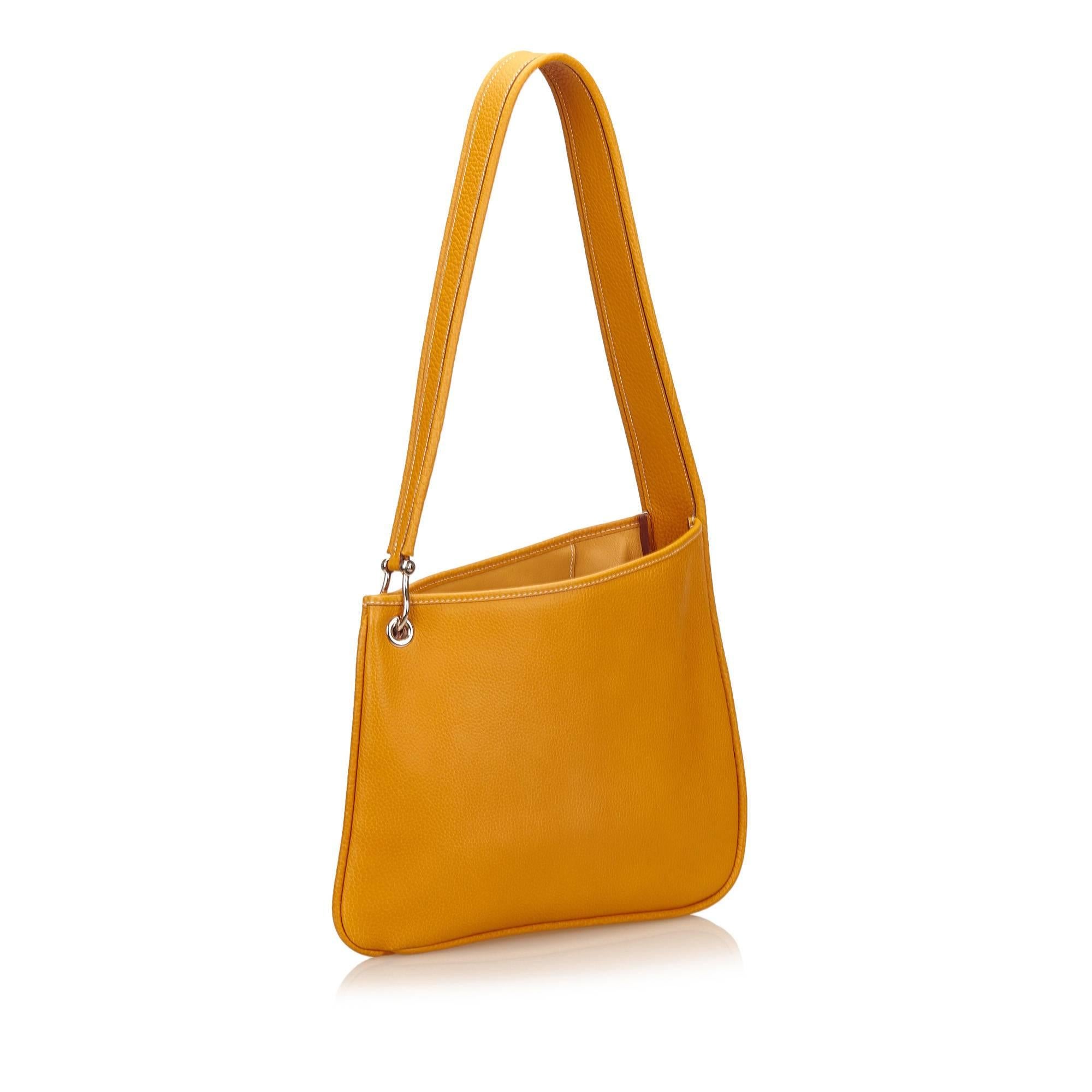 This shoulder bag features an Fjord leather body, flat leather strap, open top, and interior zip and slip pocket.