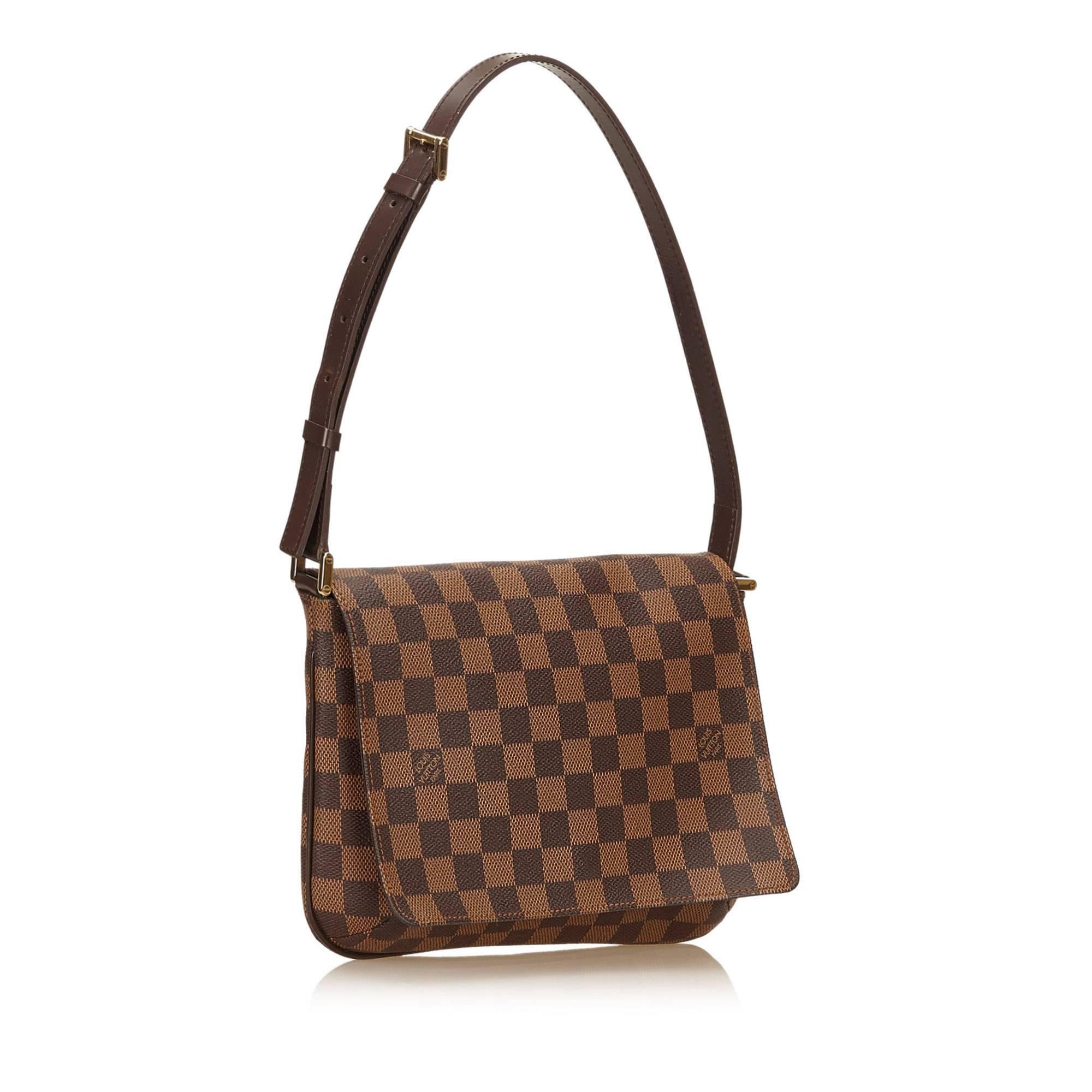 The Musette Tango features a damier ebene canvas body, a leather shoulder strap, a front flap with a magnetic closure, and an interior slip pocket. It carries a B condition rating.

Inclusions: 
This item does not come with inclusions.