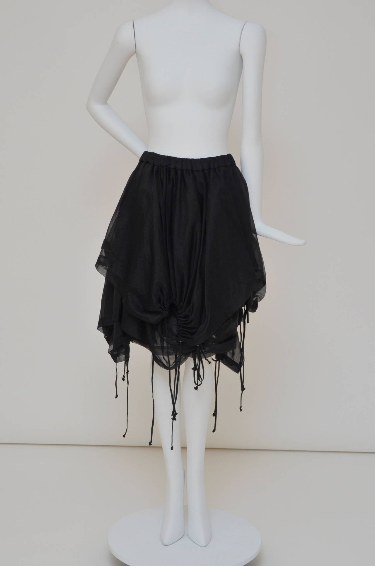 Comme des garçons layered  vintage skirt with strings.
Very unusual and unique cut,look and style.
Excellent condition with few hard to notice very little tiny  snags.
From AD 1990 .
Made in japan.Size S.
Fabric 100% nylon.

FINAL SALE.
