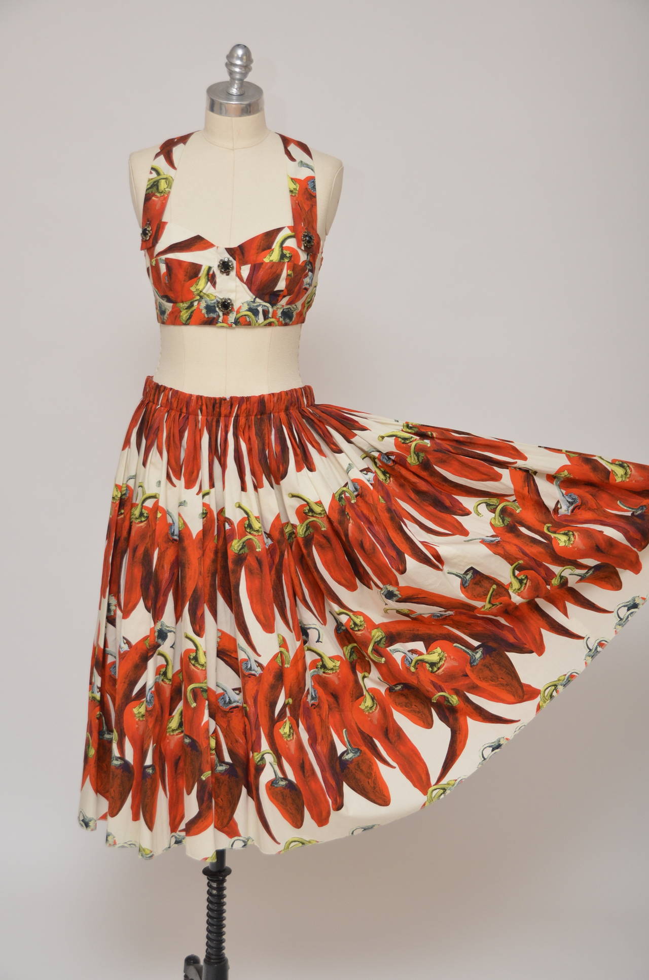 Dolce & Gabbana Chili  Peppers print set :top with matching skirt.
One of the most recognizable and popular Dolce  & Gabbana prints.
Top is size 42 IT and skirt is size 44IT.
Skirt measure:waist 15.25