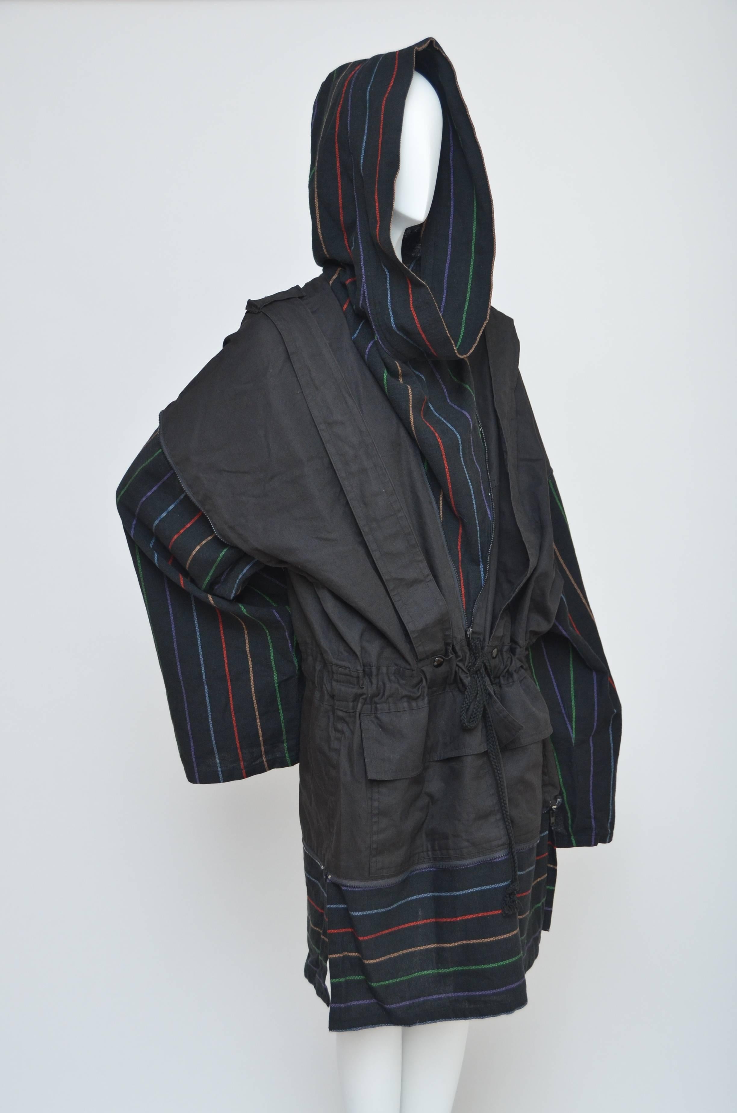 Amazing  design from  Issey Miyake  1970's era.
Convertible backpack/anorak jacket and  Miyake very early design.
Multiple zippers construction :from the sleeves that can be zipped up and tucked in as well as  hoodie  and the bottom  once everything