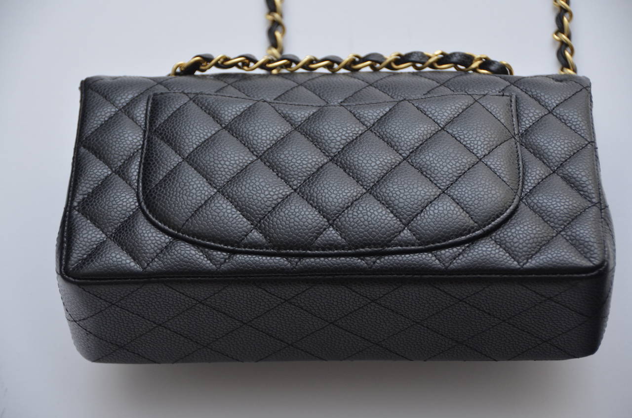 Chanel caviar leather double flap handbag.
Excellent  condition.
Come with matching card and dust bag.
Gold tone hardware with turn lock closure.Lined in lambskin leather.
Approx. bag measurements:L 9