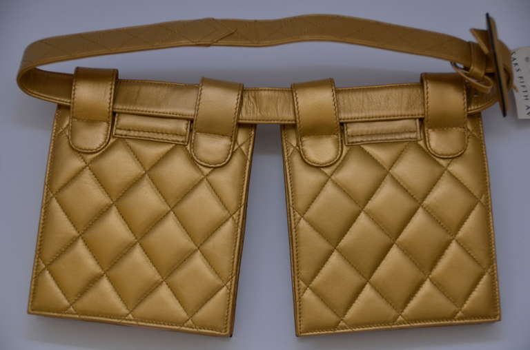 Chanel gold color belt comes with 2 waist bags.Bags are not attached to a belt and can be removed and worn as set or single.New with tags from Saks Fifth Avenue.Excellent condition.
Bags are lined inside  with lambskin leather and have little