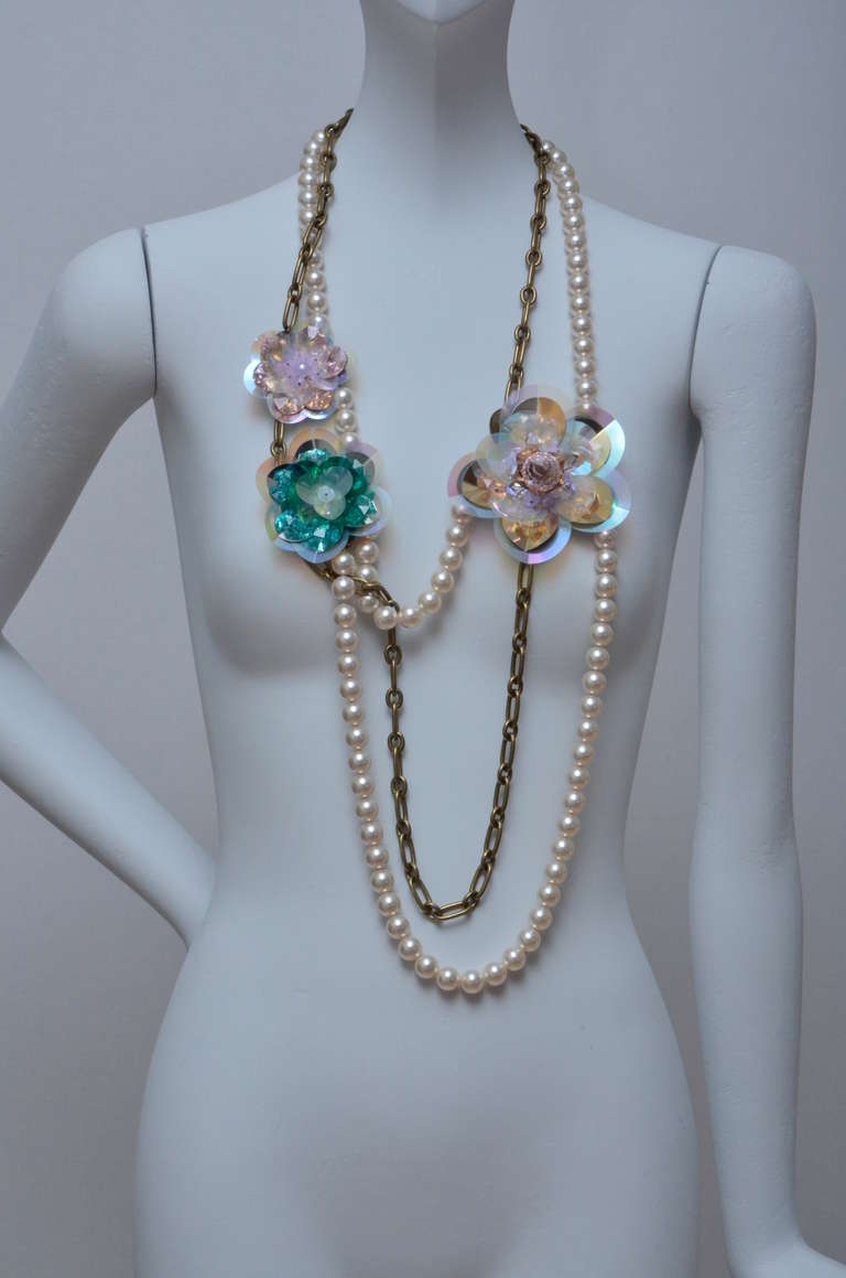 Fabulous LANVIN hand made multi strand necklace of pearls, chain links and flowers.
Beautiful iridescent sautoir flowers in pinks, gold, blues and clear keep the strands in asymmetrical place.
Flowers have sequin detail.Signature stamps on