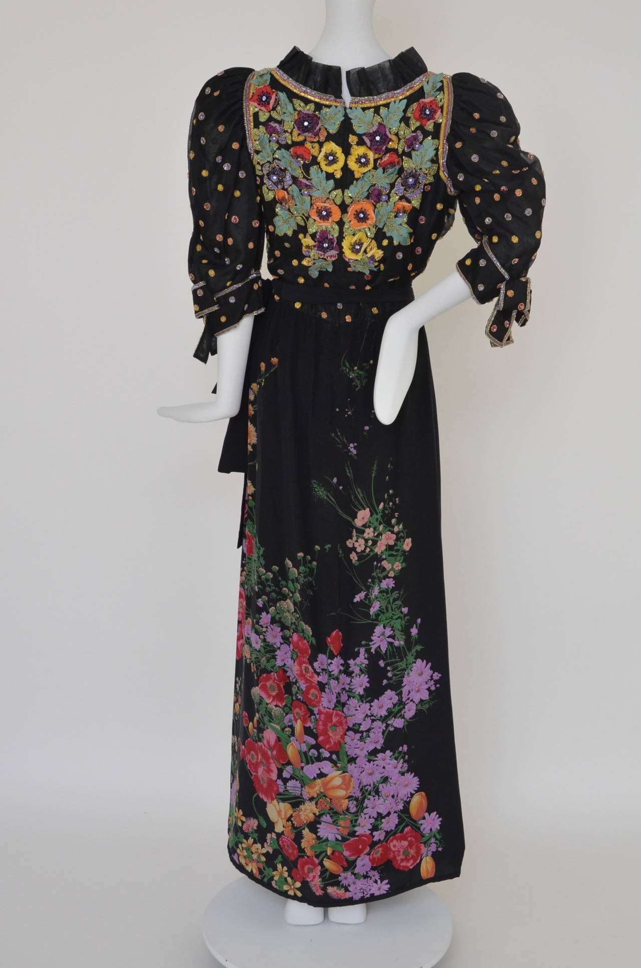 Tiziani couture beaded black   dress.Probably designed by Karl Lagerfeld, mid 1960s.Tiziani Roma label.Top  adorned with a green leafs and flowers embellished with  different color of  rhinestones and beads.Sleeves are beaded with bow tie on the