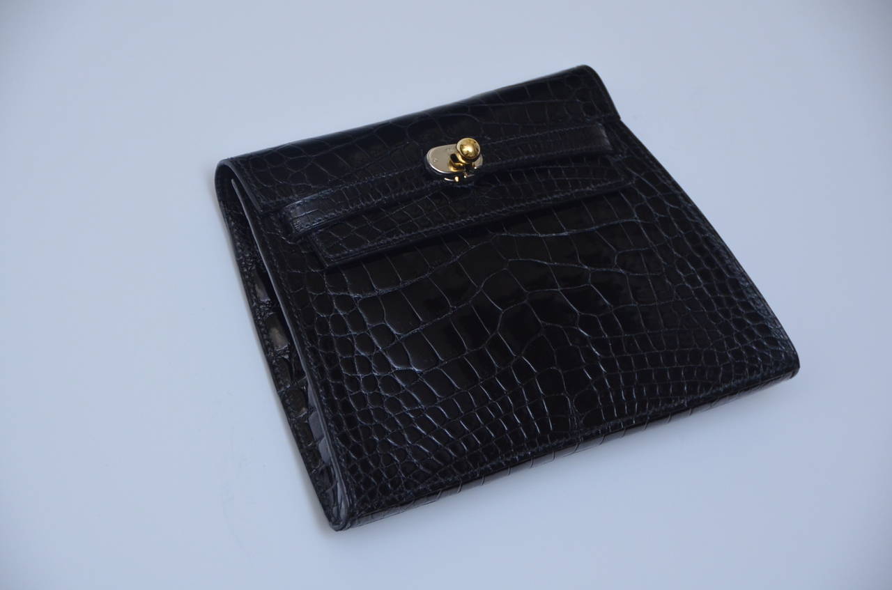 Gorgeous very rare Hermes mini  crocodile clutch.
This one of a kind rare bag is so beautiful and unique.
Perfect mini evening or special occasion  bag .
Excellent mint vintage  condition.
Shiny black crocodile skin with mix  gold and silver