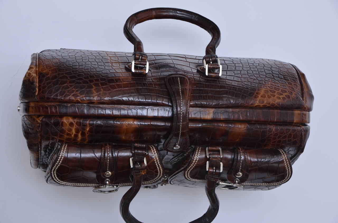 Absolute  ultimate luxury  special  LIMITED EDITION  John Galliano for Christian Dior crocodile voyage handbag.Finest crocodile with  dark brown  leather lining inside and decorative stitching on the outside.Seen  on the  2005 runway .
Only special
