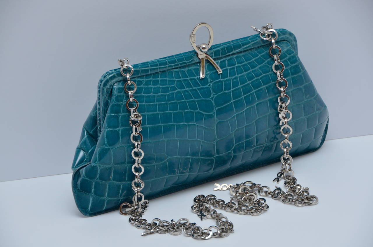 ROBERTA DI CAMERINO Crocodile Clutch Handbag .
Mint condition.
Could be worn as shoulder bag or as clutch.
Beautiful turquoise color crocodile.
Silver chain hardware with little signature R charms.
Handbag measure: H 6