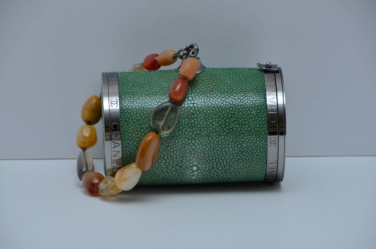 CHANEL  Mini Barrel Green Stingray Cylinder Wristlet.
Rare and unique Chanel bag that will get anyone's attention.
Excellent vintage condition.Lined in green leather inside.
Handle with natural stones .
Silver tone hardware with CHANEL all