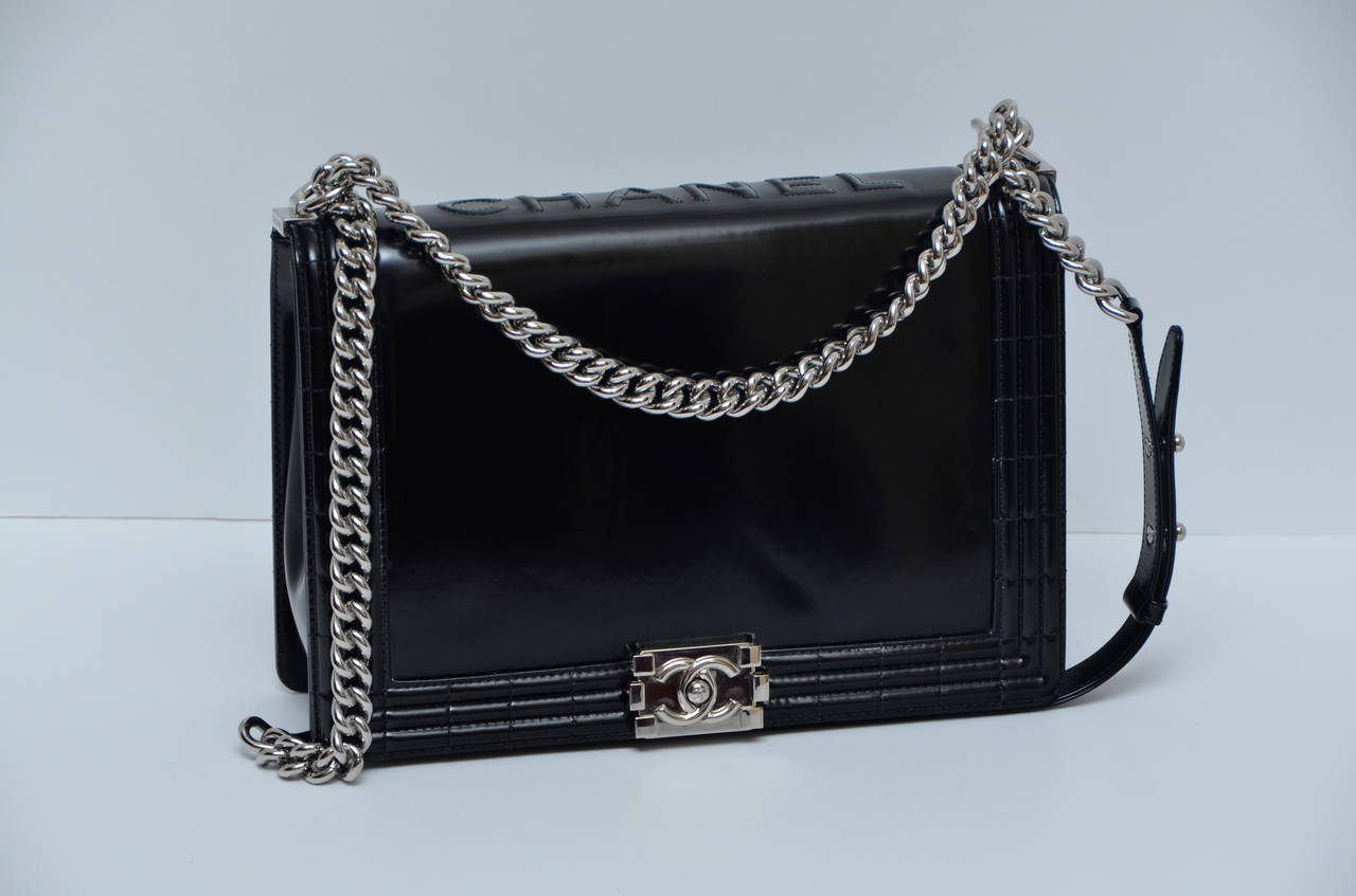 Black Chanel  Boy flap handbag.
This chic shoulder bag is crafted of luxuriously glazed smooth black calfskin leather with quilting that frames the flap edges. The bag features a silver chain shoulder strap with a leather shoulder pad, and a