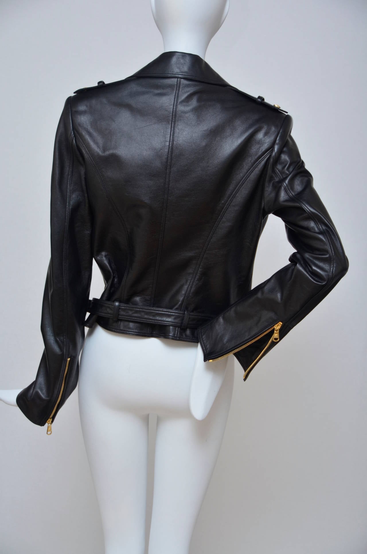 Versace black Leather Biker Jacket.
Black leather epaulettes, studded lapels, zipped cuffs, two zipped front pockets, front flap pocket, fully lined exposed asymmetric zip fastening through front 100% leather (lamb); lining: 96% rayon, 4% elastane