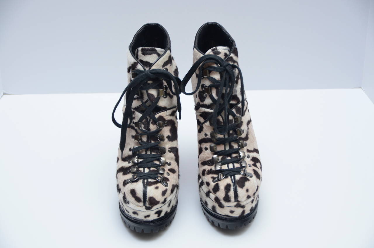 These ALAIA Snow Leopard Ponyhair Platform Hiking Boots are extremely desirable, and they are loved by many celebrities. Sold out and very hard to find.
Featurs a covered platform sole and stiletto heel. Black leather trim at ankle and lace up
