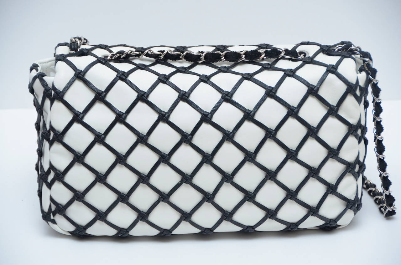 Chanel white lambskin jumbo size handbag.
Covered with black leather 