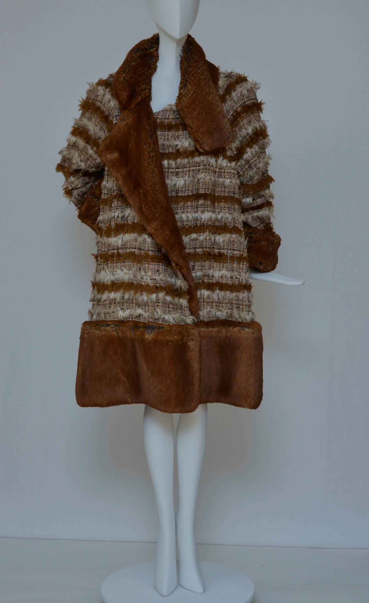 One of a kind Chanel  Fall Winter 2010 Collection classic fringed tweed and fantasy fur (faux fur) coat. 
Size 46. 
This coat is in excellent preowned  condition. 
Gorgeous timeless piece with beautiful detailing. Impossible to find, rare,